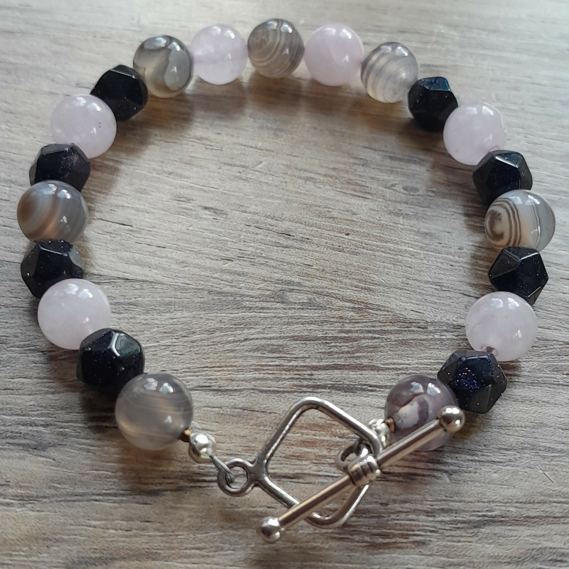 Tibetan Silver Toggle Catch Bracelet with Grey Banded Agate, Faceted Navy Goldstone and Rose Quartz.