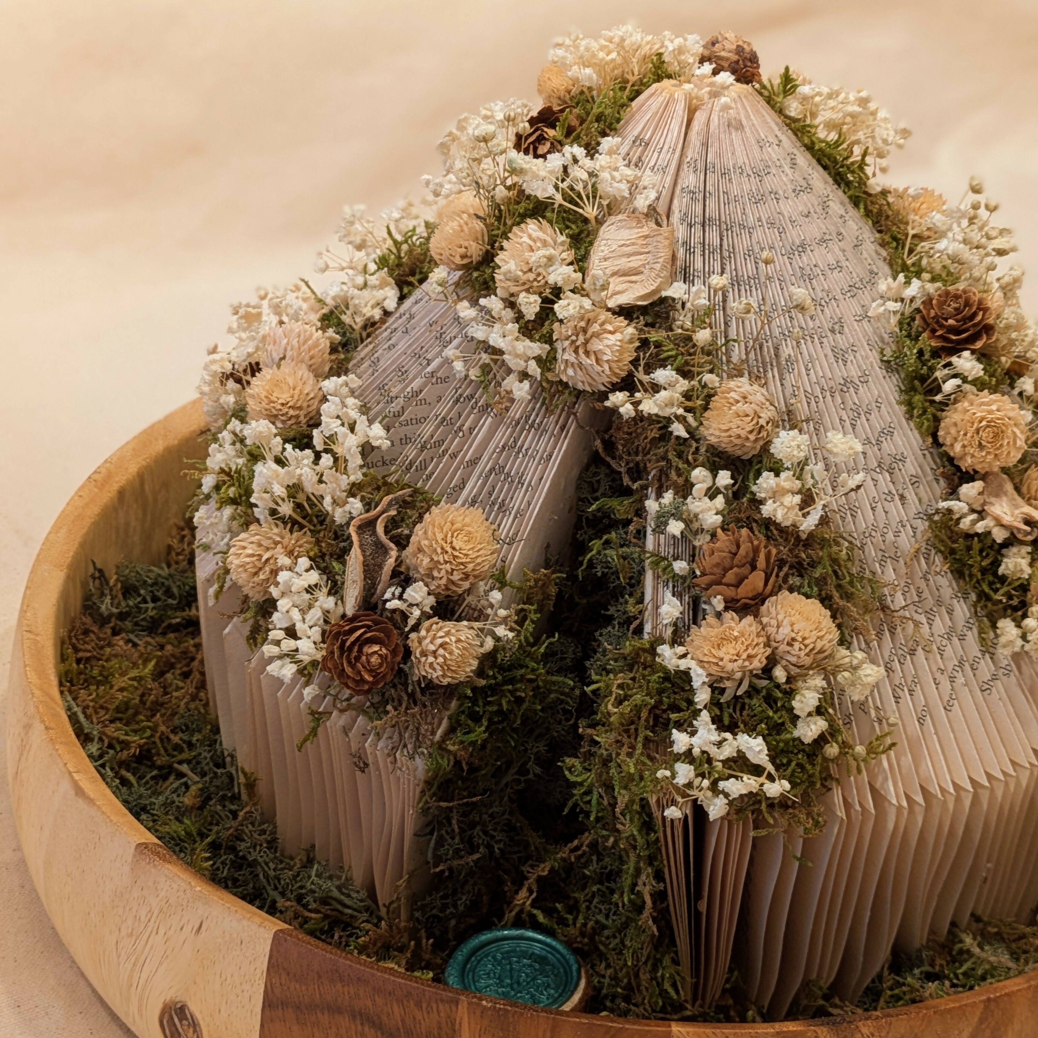 Warm Floral Arrangement on Circular Book in Wooden Tray