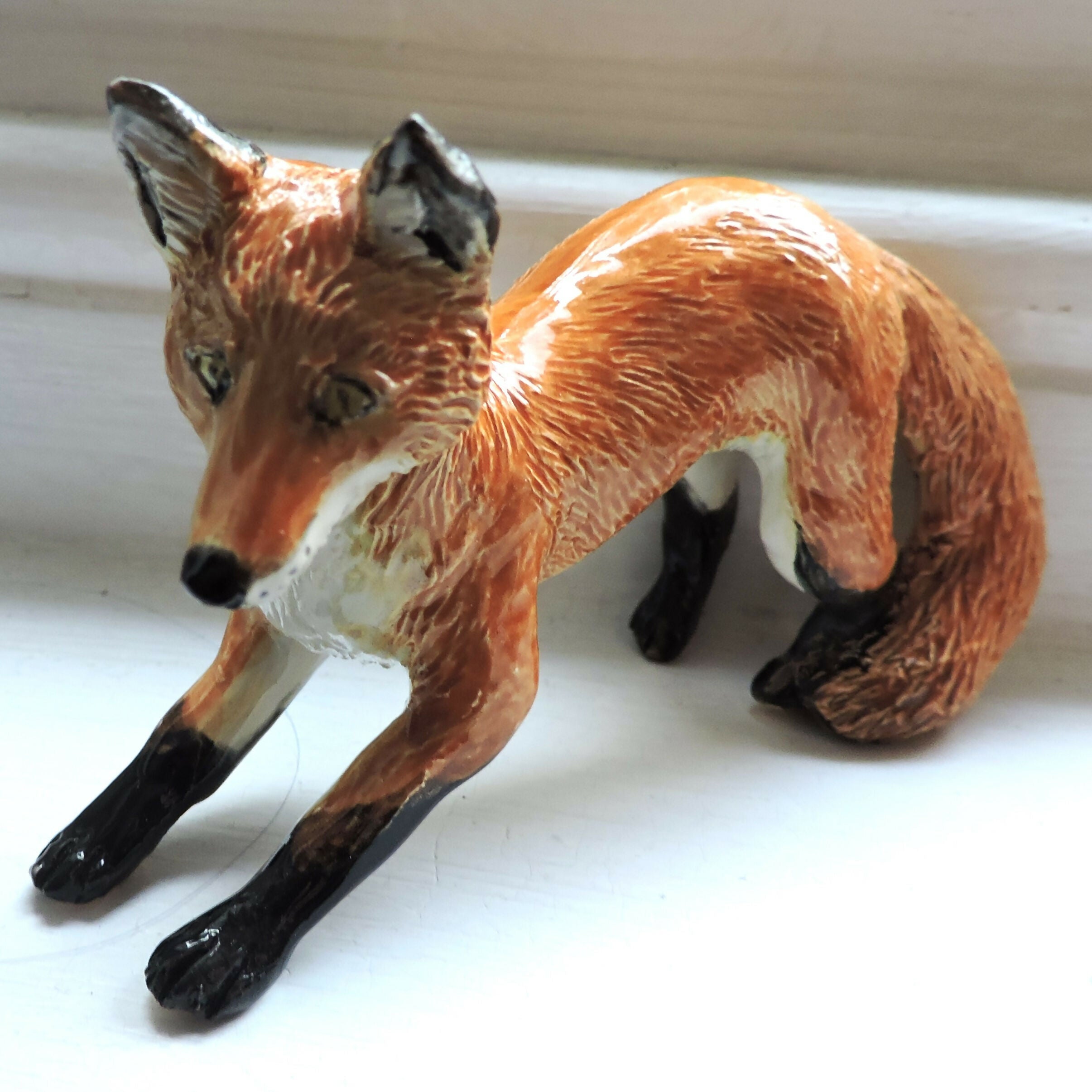 Ceramic pouncing fox sculpture