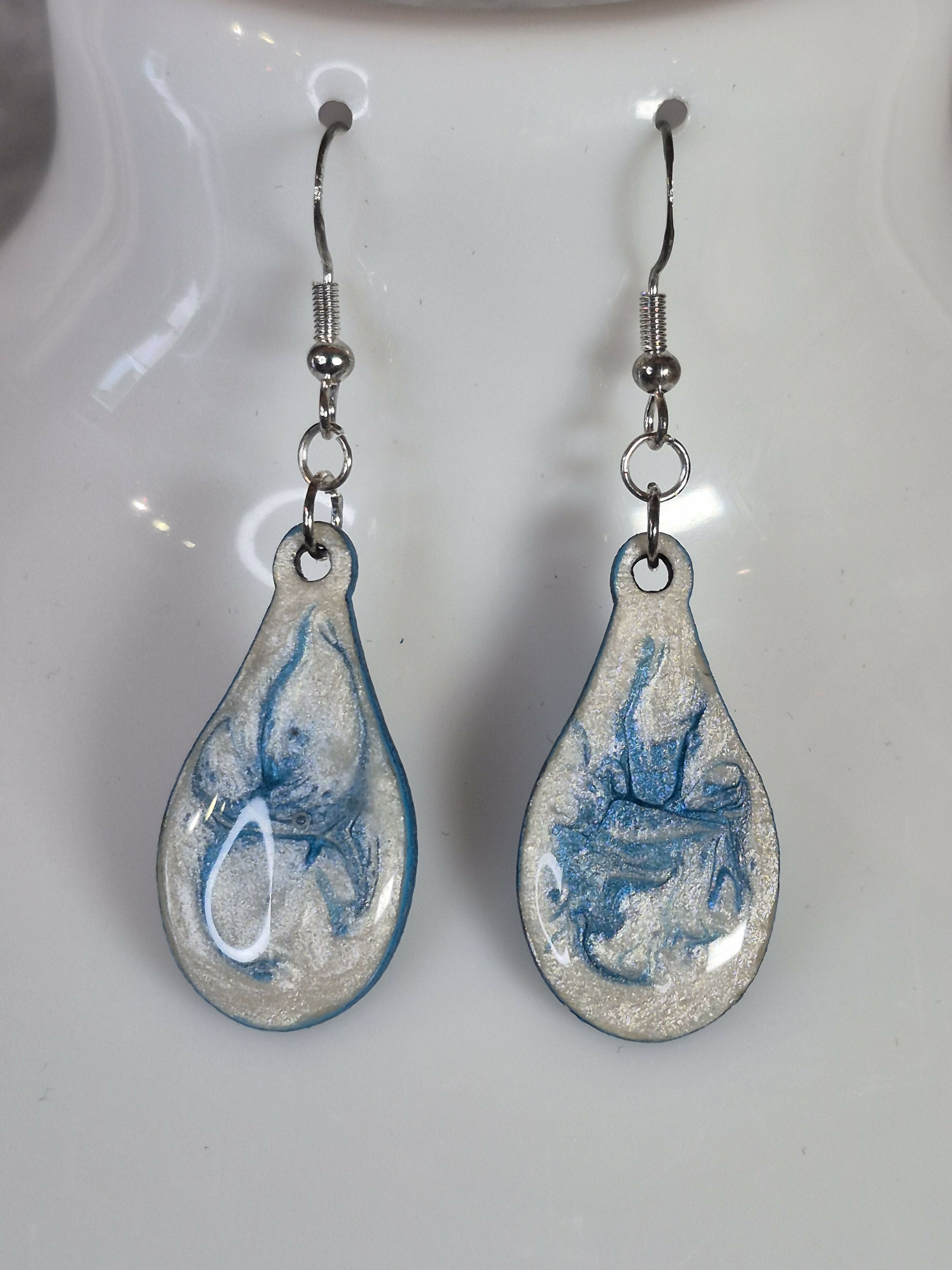 Handcrafted teardrop ivory and cyan colour earrings.