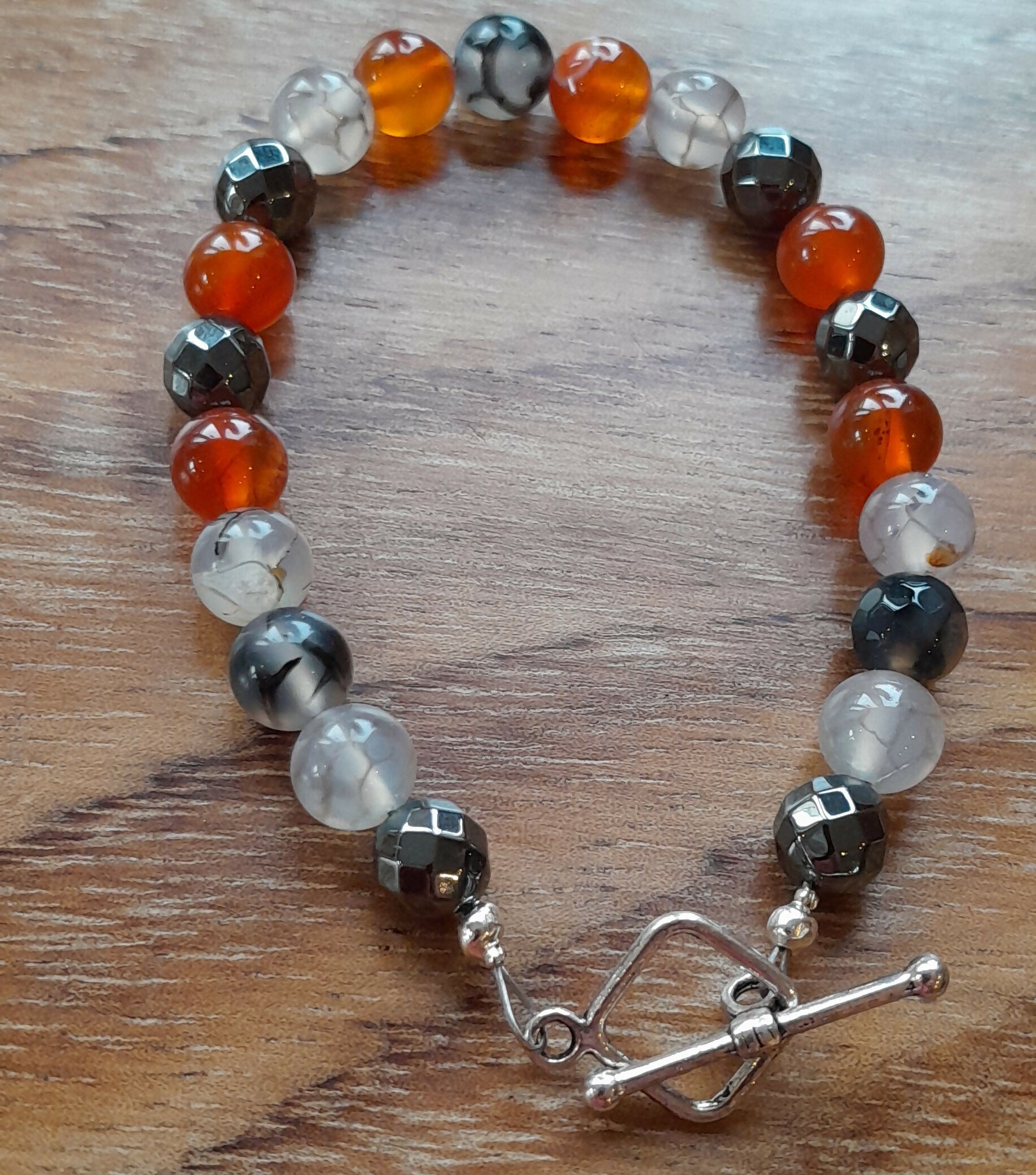 Gemstone Bracelet with a Tibetan Silver Toggle Catch, Faceted Grey Hematite, Faceted Dragon's Vein Fire Agate and Carnelian.