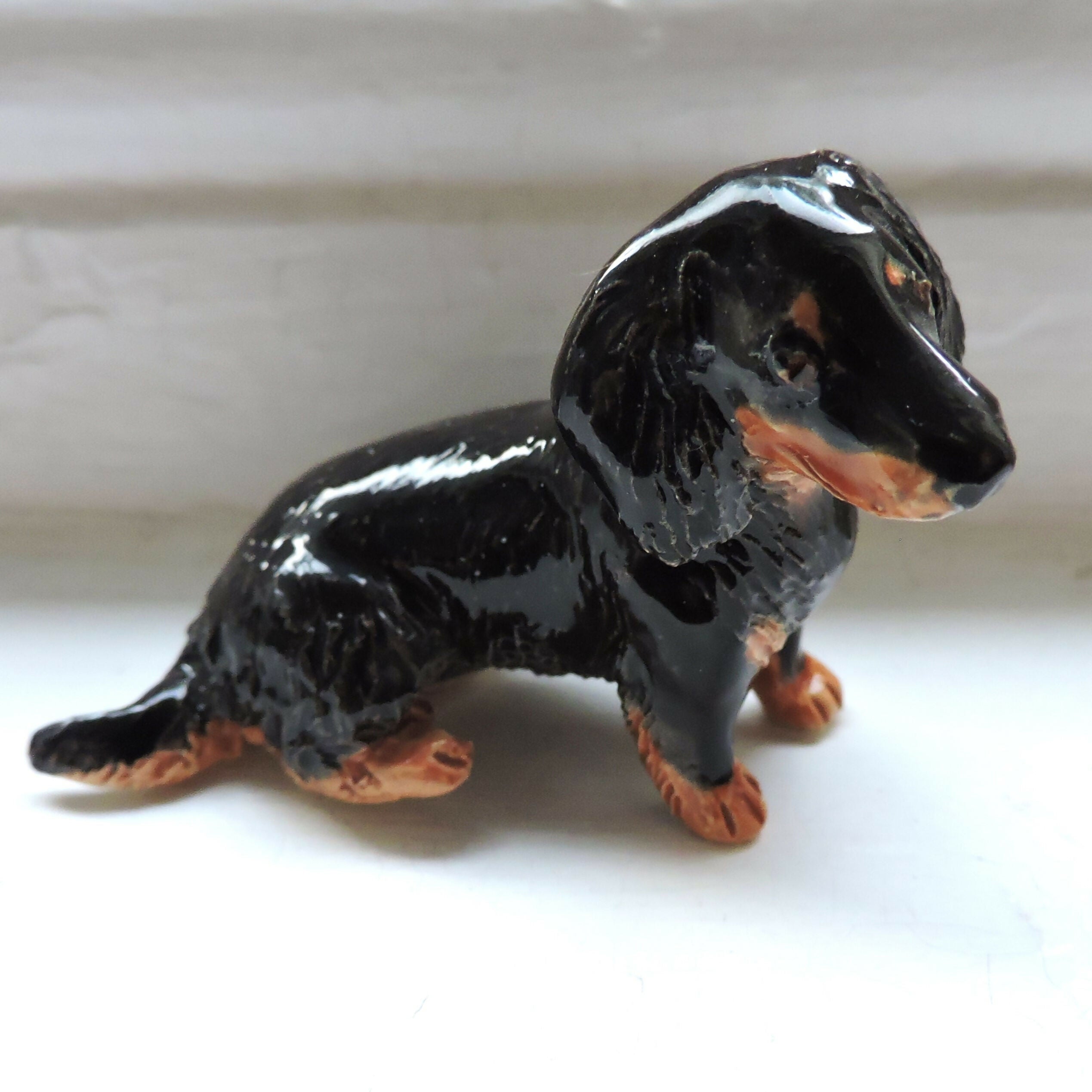Ceramic Longhaired Black and tan dachshund dog sculpture