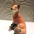 Ceramic sitting fox sculpture