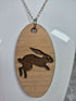Unique Handcrafted, Oval, Cherry Veneered, Pendant With An Engraved Leaping Hare