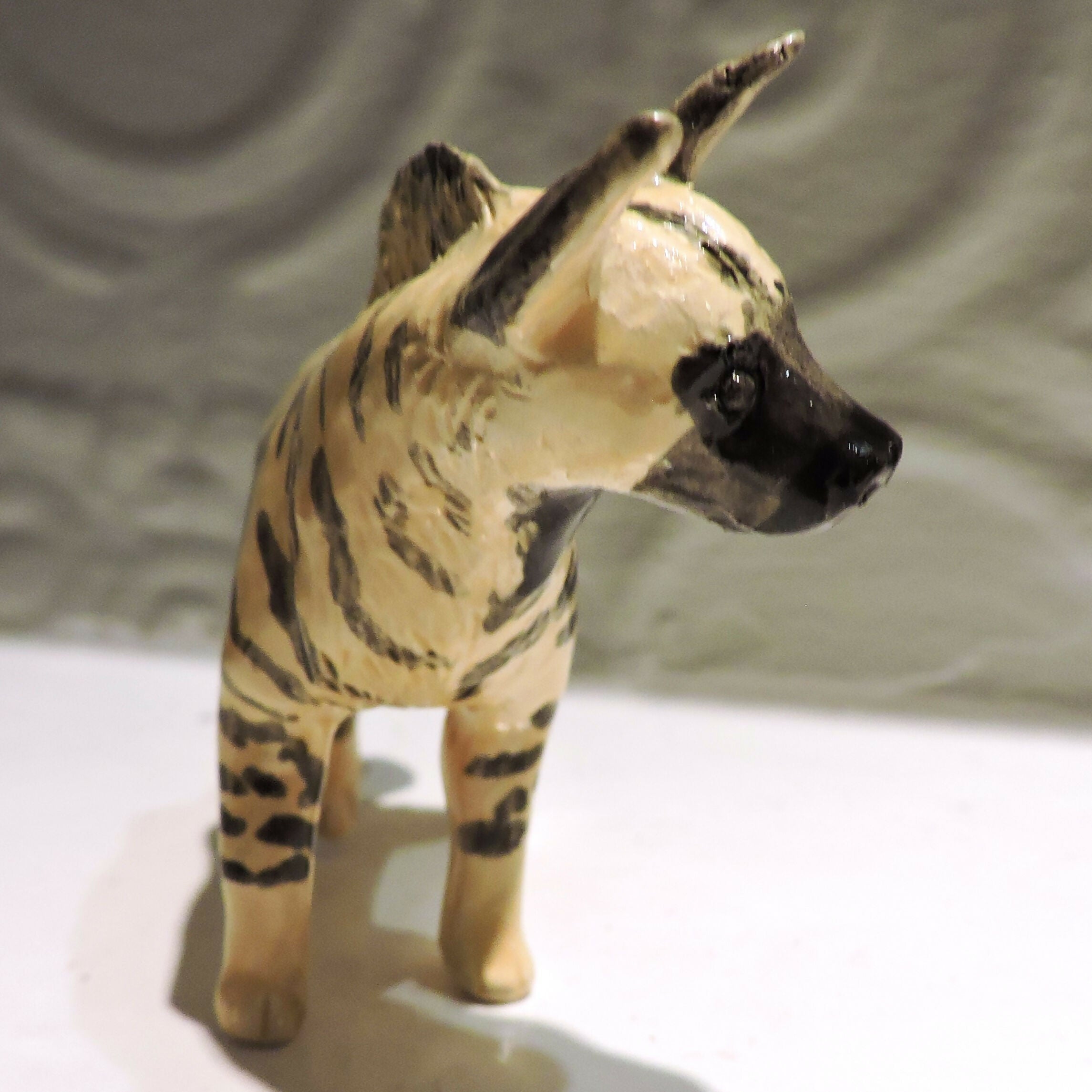Ceramic striped hyena sculpture