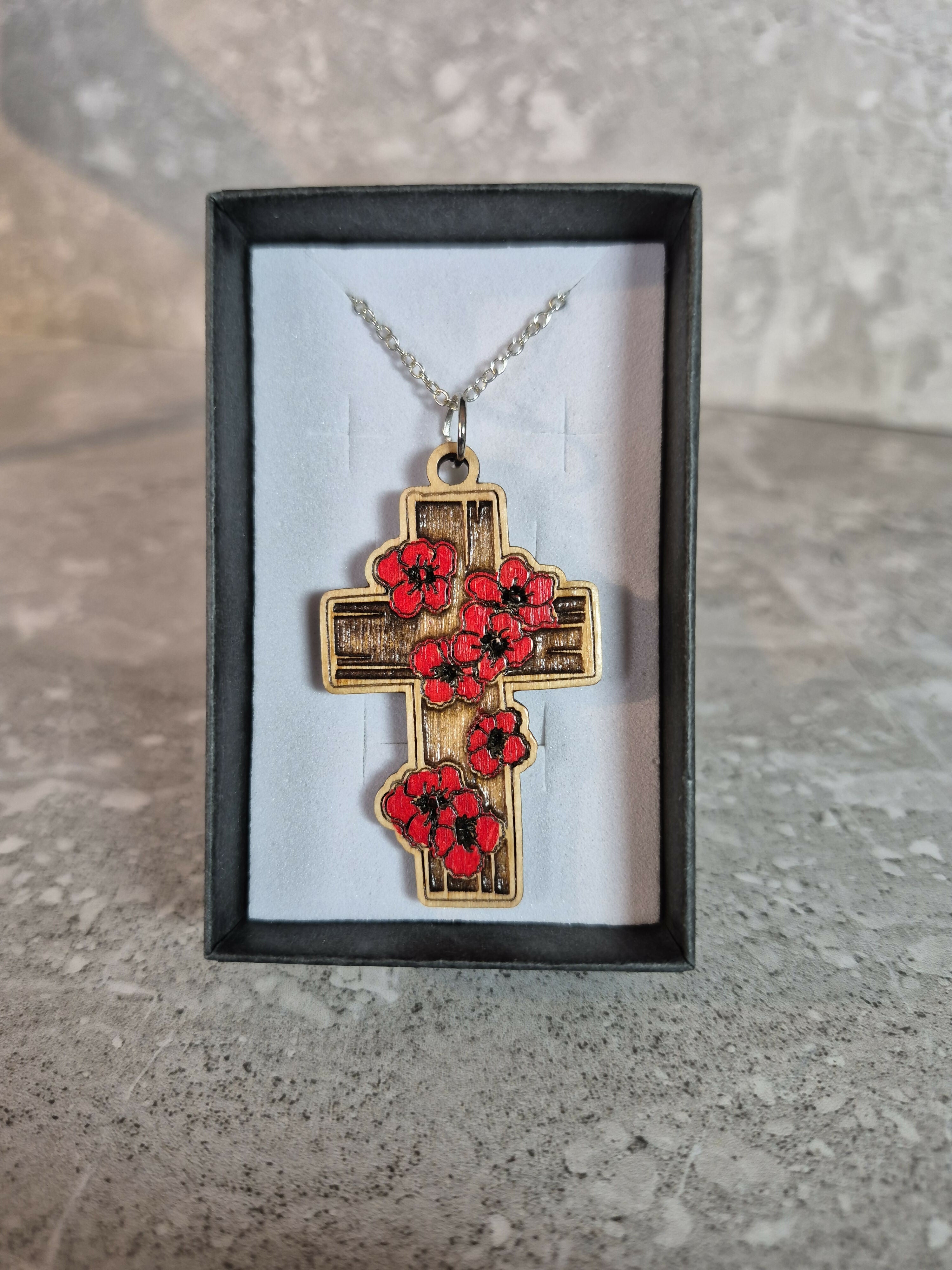 Handcrafted and engraved red poppy cross.