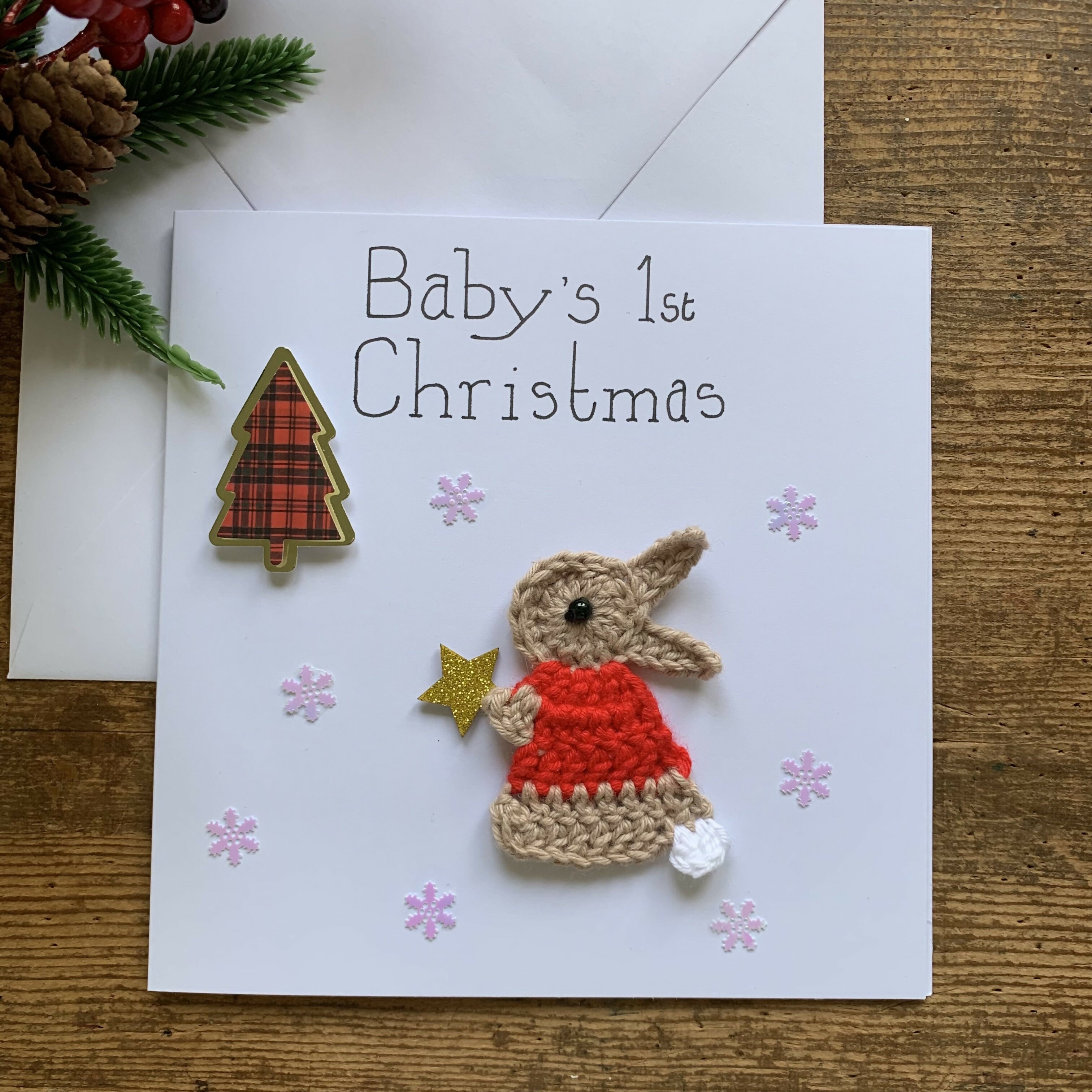 Christmas Card with Crocheted Rabbit Putting Star on the Christmas tree.