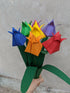 bouquet of seven origami tulips in rainbow colours with green paper leaves