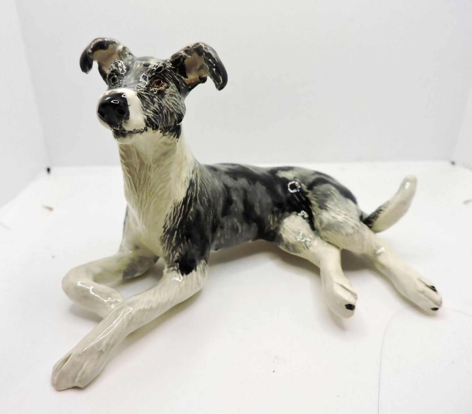 Ceramic Rough coated lurcher dog sculpture, merle