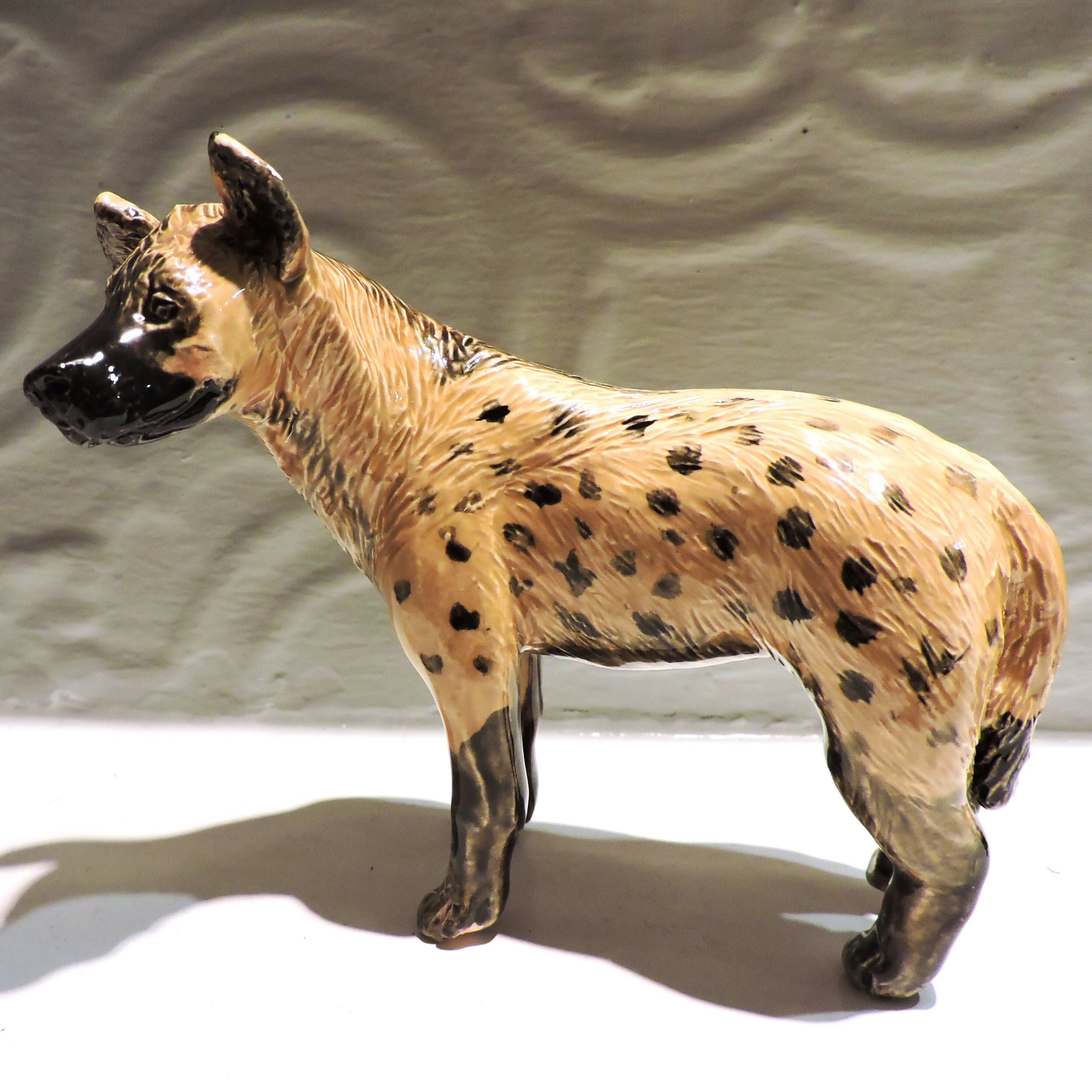 Ceramic spotted hyena sculpture