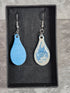 Handcrafted teardrop ivory and cyan colour earrings.