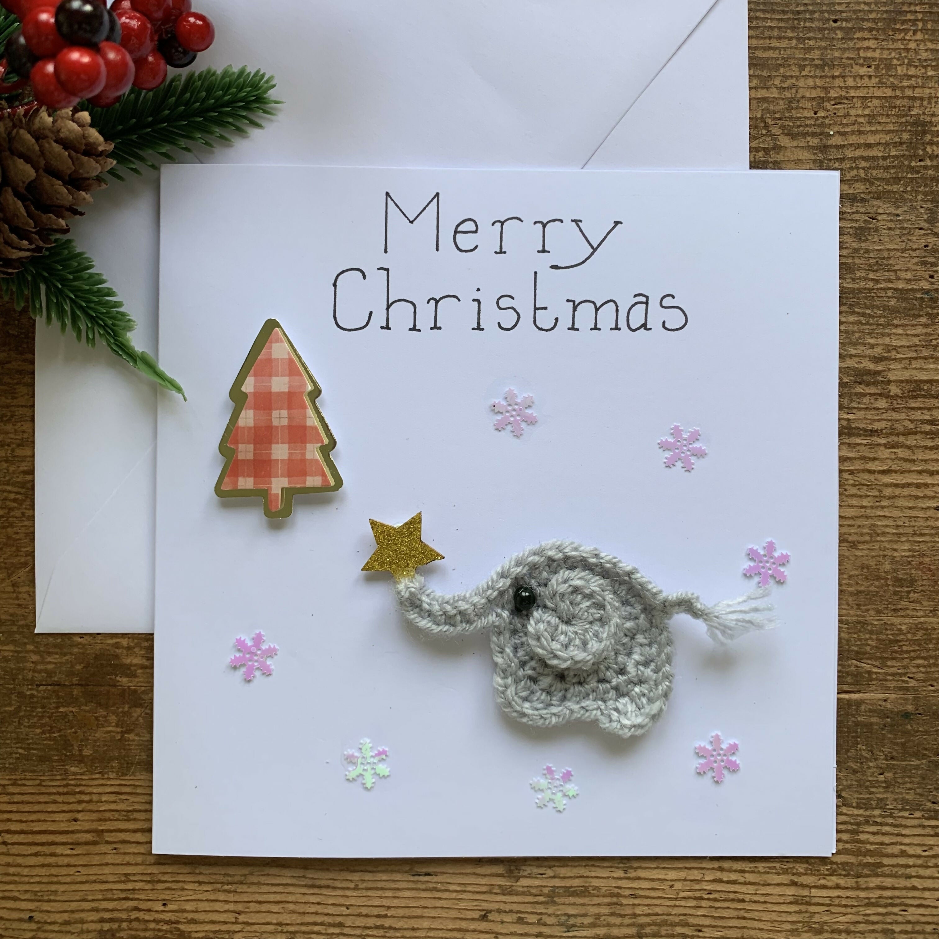 Christmas Card with Crocheted Elephant Putting Star on the Christmas tree.