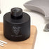 Reed Diffuser with black glass bottle and white reeds
