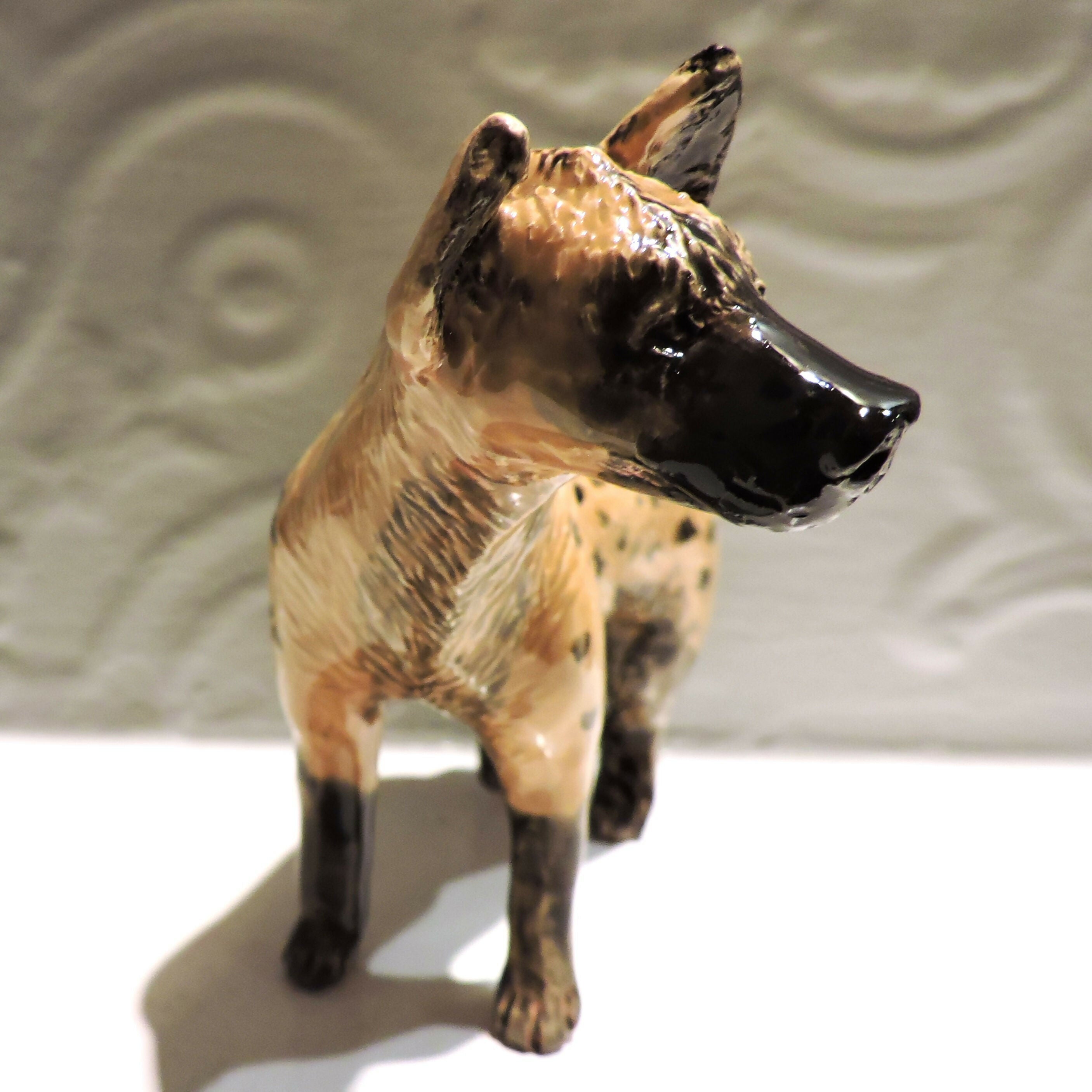 Ceramic spotted hyena sculpture