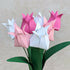 bouquet of seven origami tulips in pinks and white with green paper leaves
