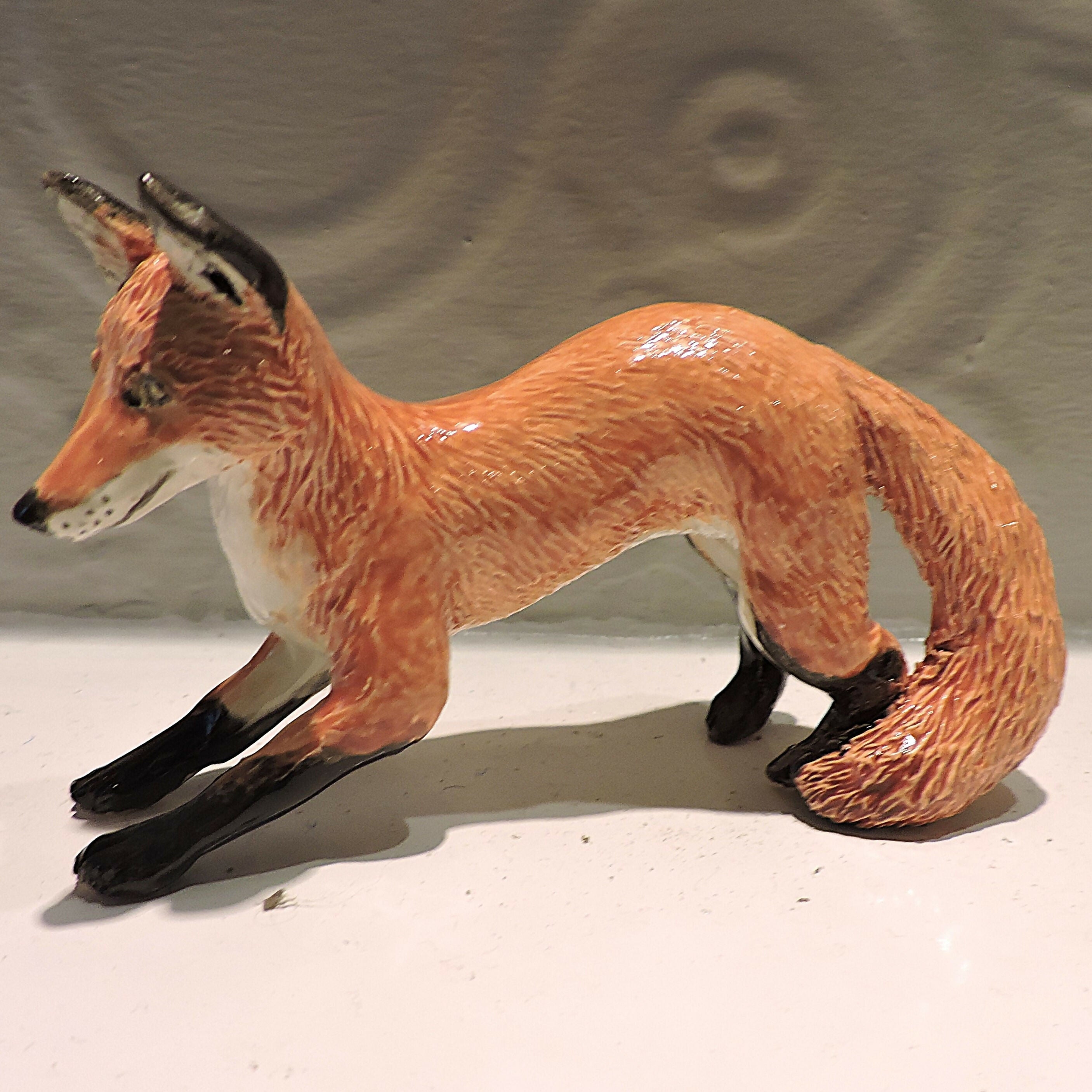 Ceramic pouncing fox sculpture