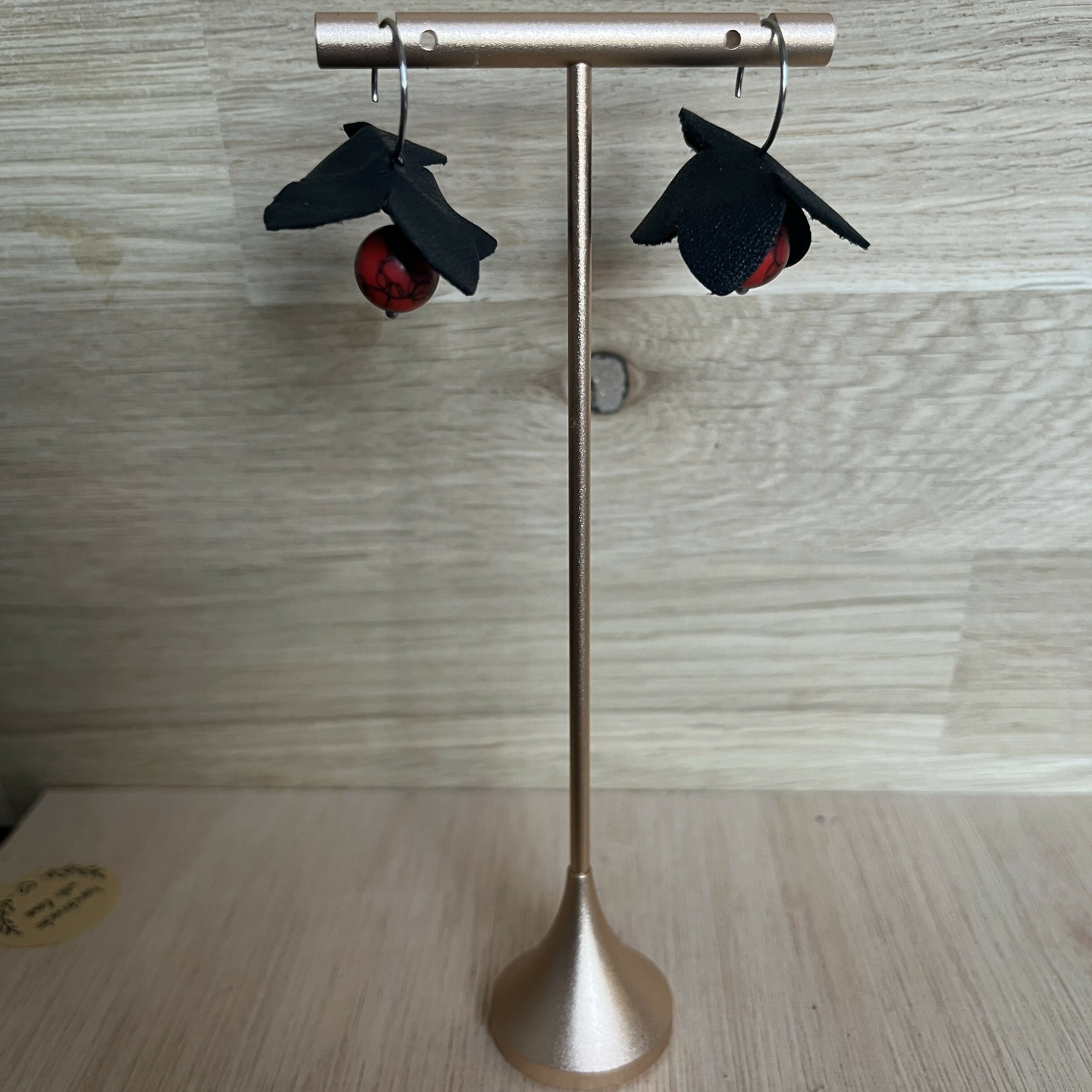 Forest Whisper – Black Leather Flower Earrings with Red Stone