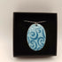 Pale Blue Enamel Pendant with Dark Blue Swirl Pattern