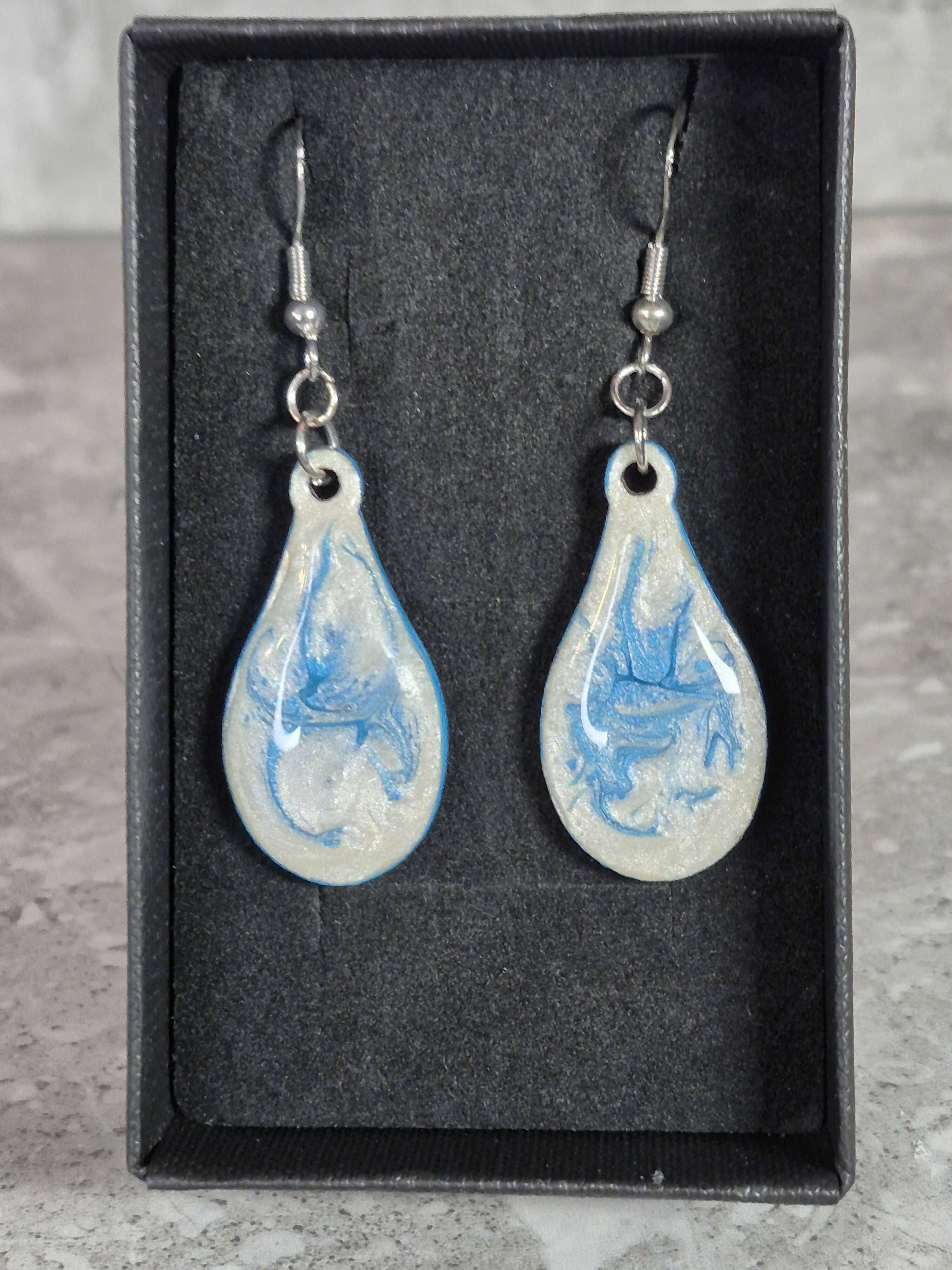 Handcrafted teardrop ivory and cyan colour earrings.
