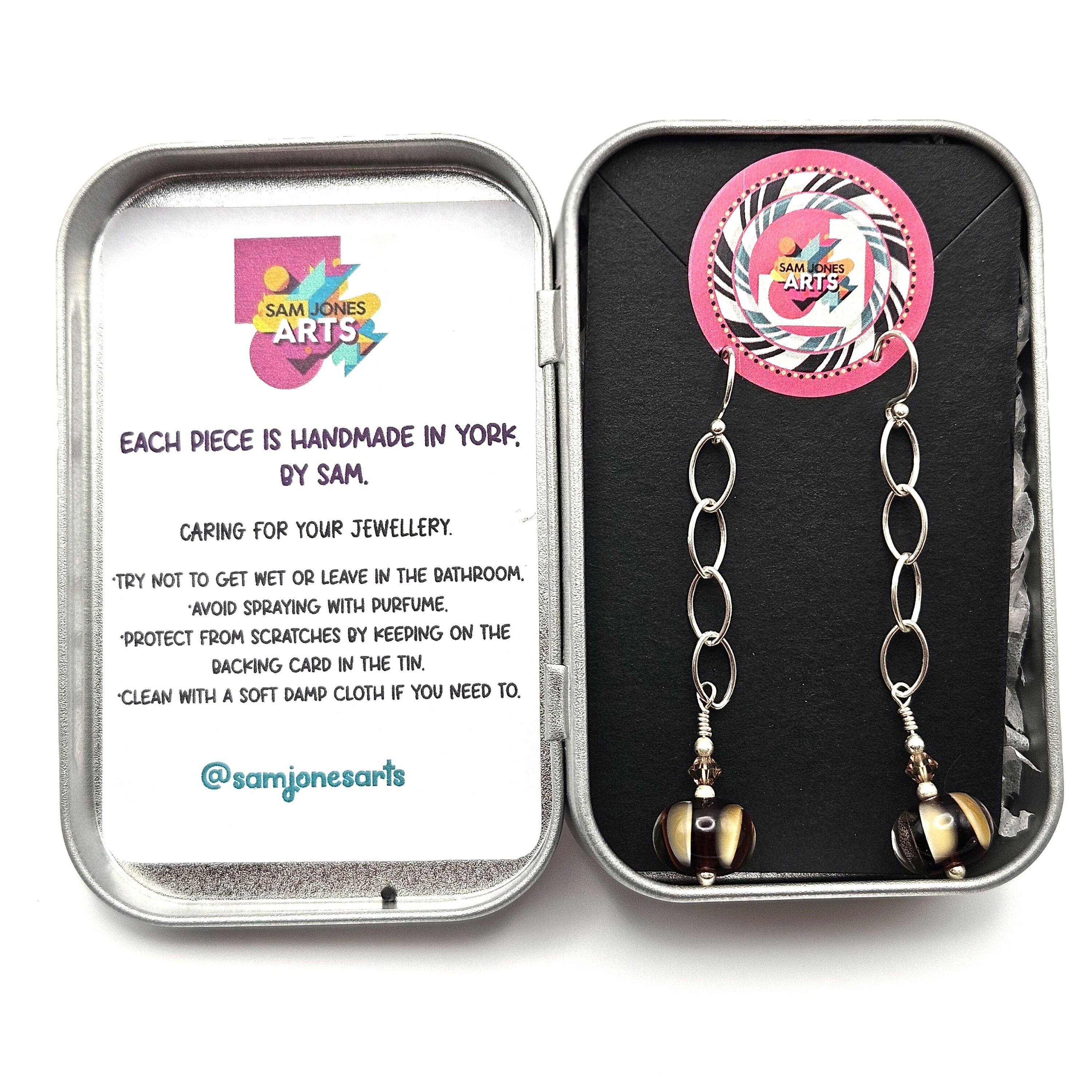 HAND LAMPWORKED GLASS HUMBUG EARRINGS, WITH STERLING SILVER CHAIN , STERLING SILVER EAR WIRES AND SWAROVSKI CRYSTALS.