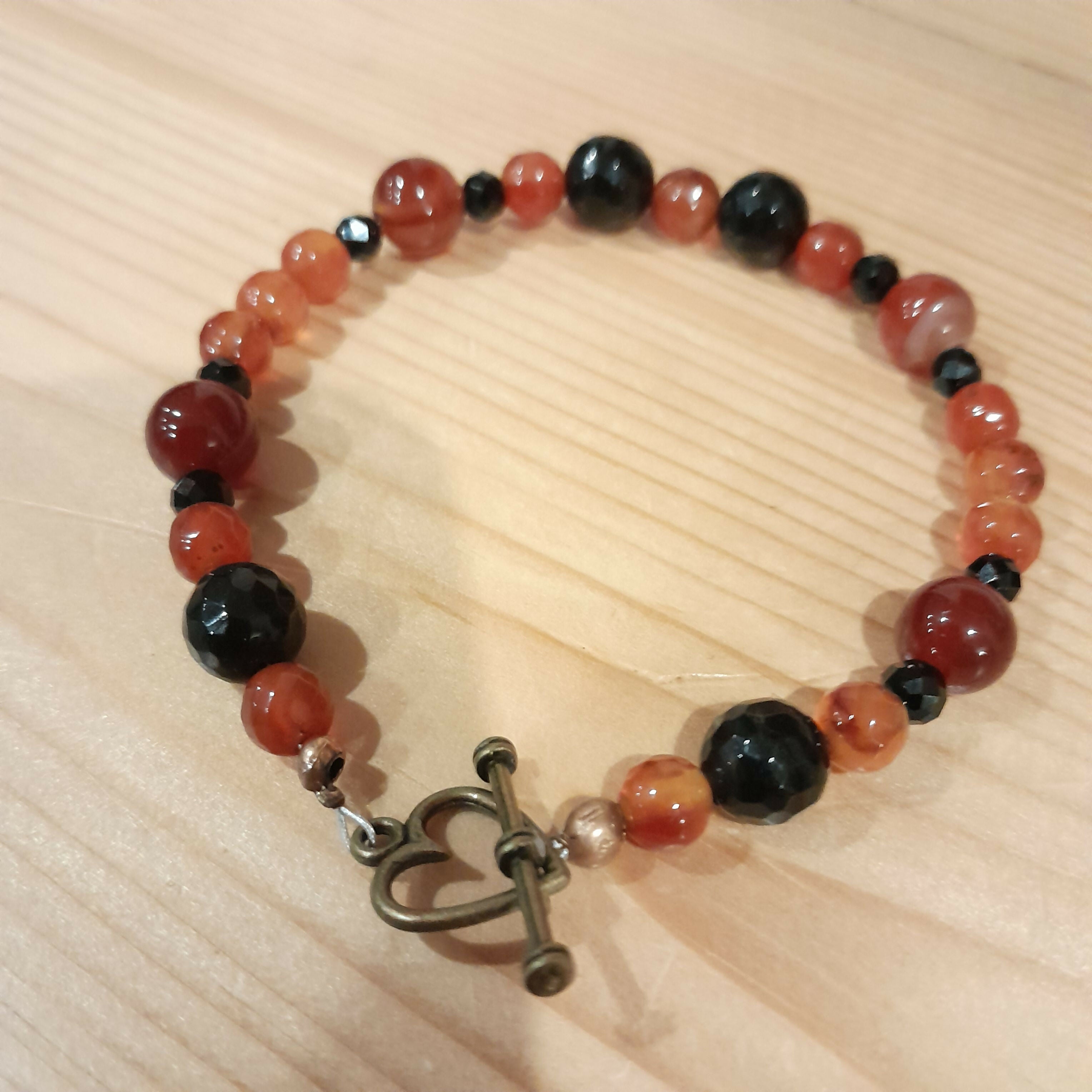 Bronze Toggle Catch Bracelet with Faceted Carnelian and Faceted Onyx.
