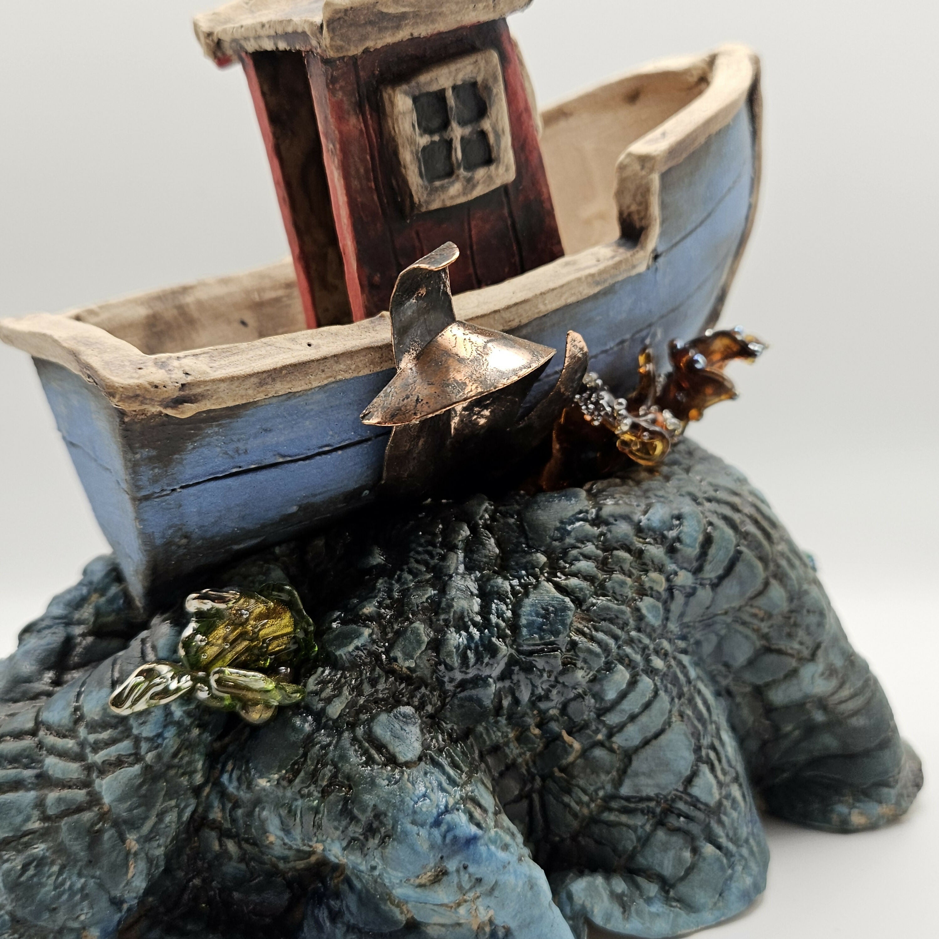'SEAS THE DAY' CERAMIC BOAT ON WAVES WITH GLASS ELEMENTS