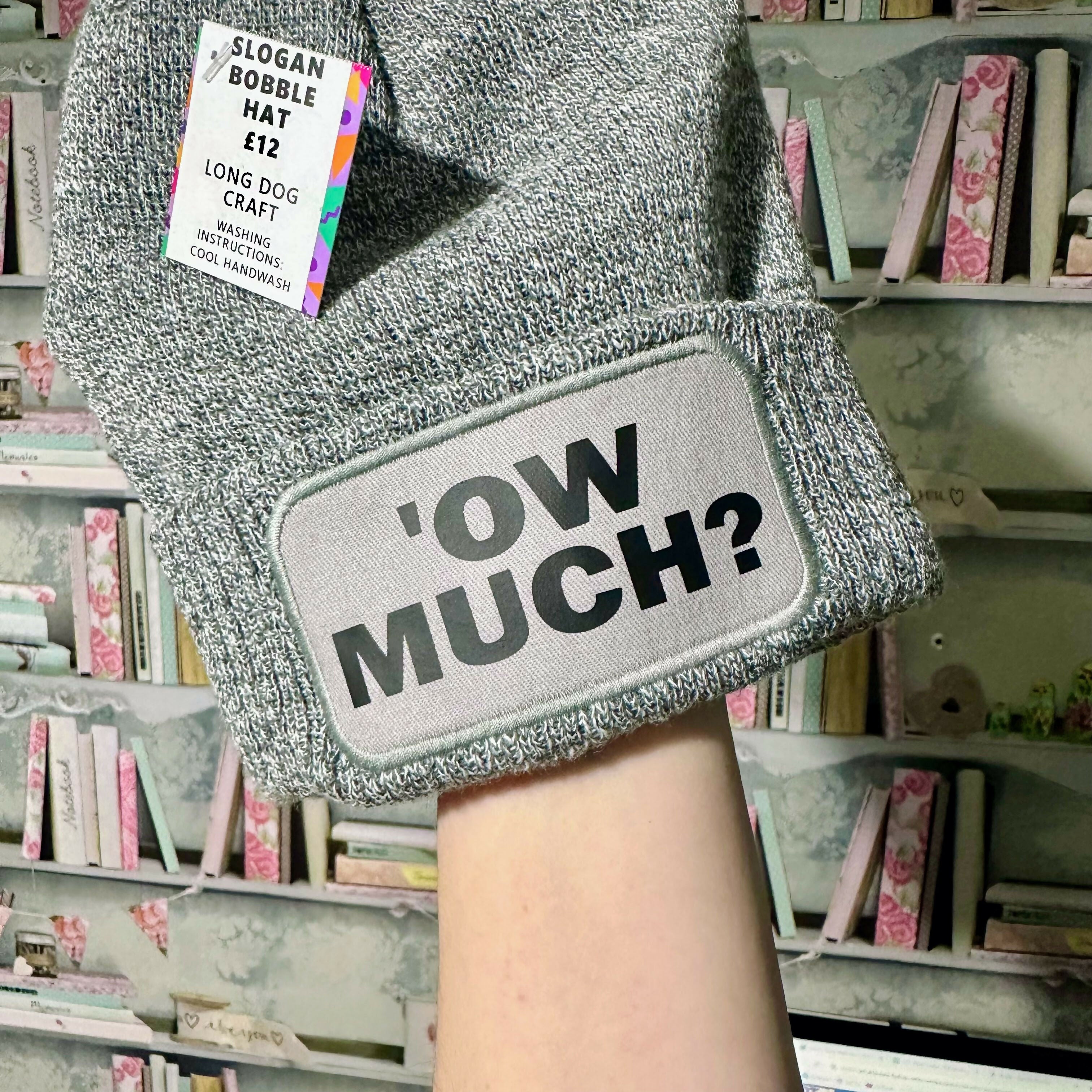 Ow Much Cuffed Rectangular Patch Bobble Hat