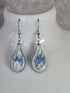 Handcrafted teardrop ivory and cyan colour earrings.