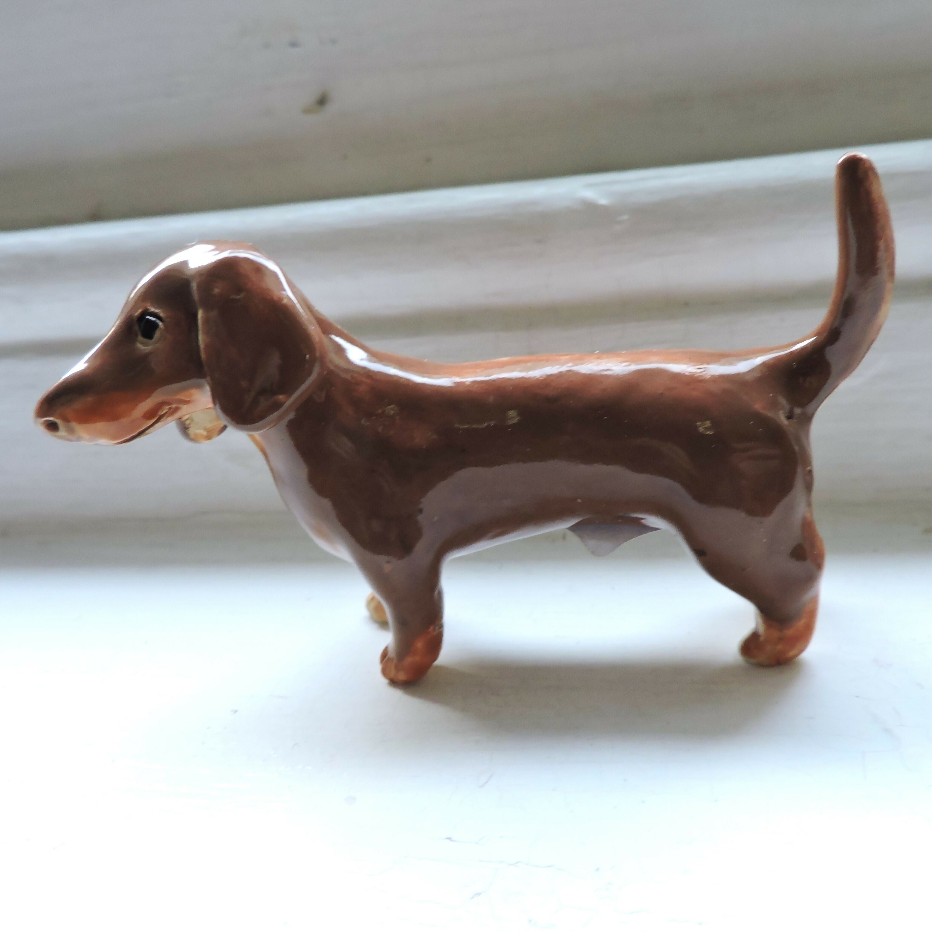 Ceramic Chocolate and tan dachshund dog sculpture