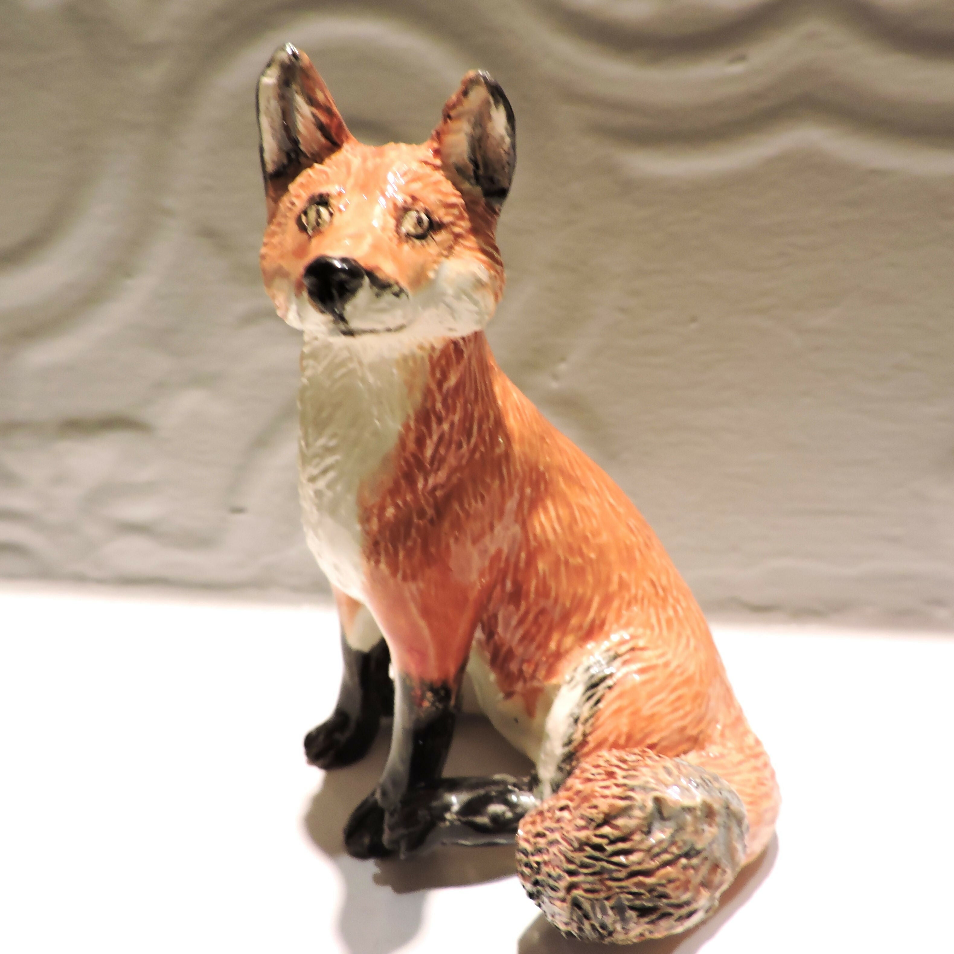 Ceramic sitting fox sculpture