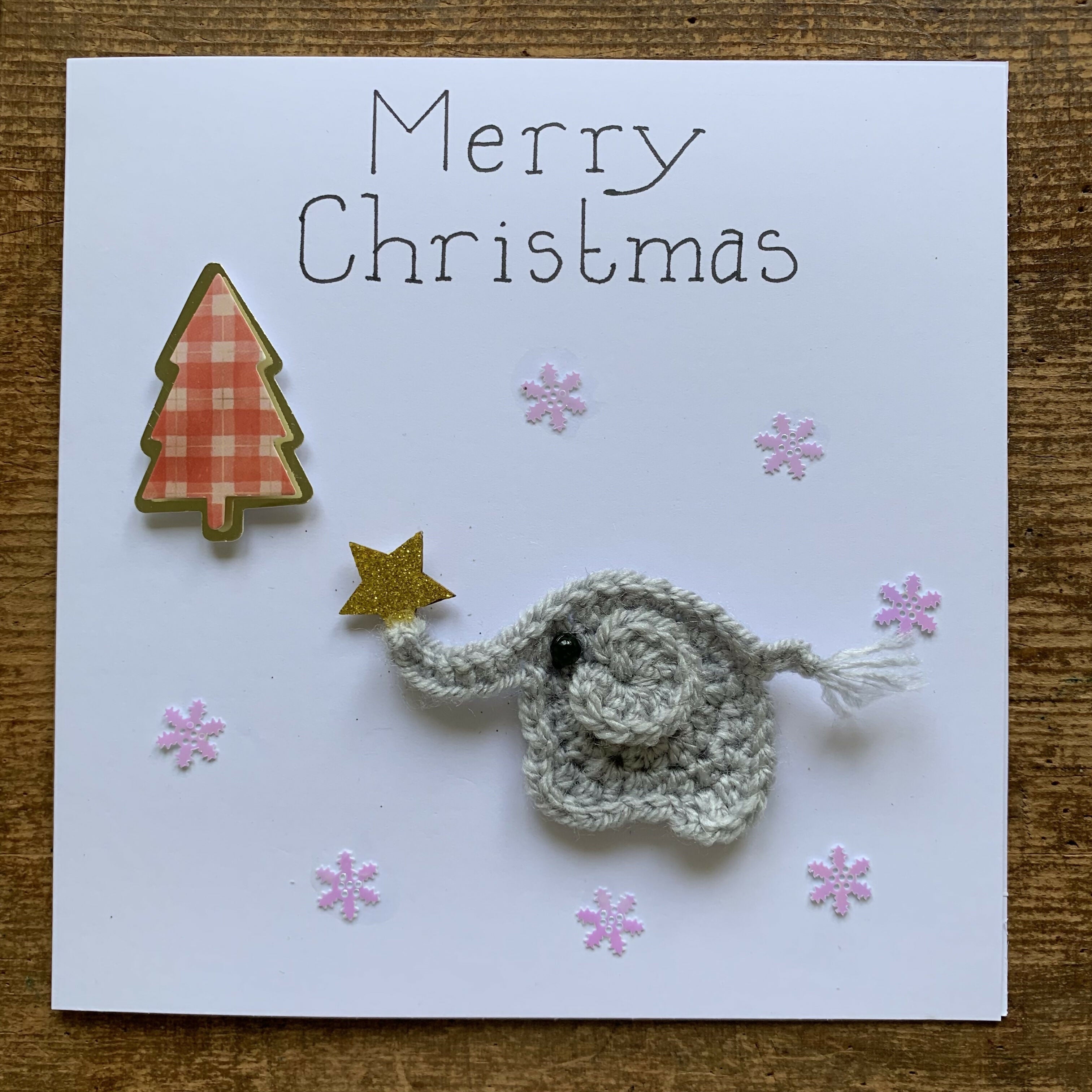 Christmas Card with Crocheted Elephant Putting Star on the Christmas tree.