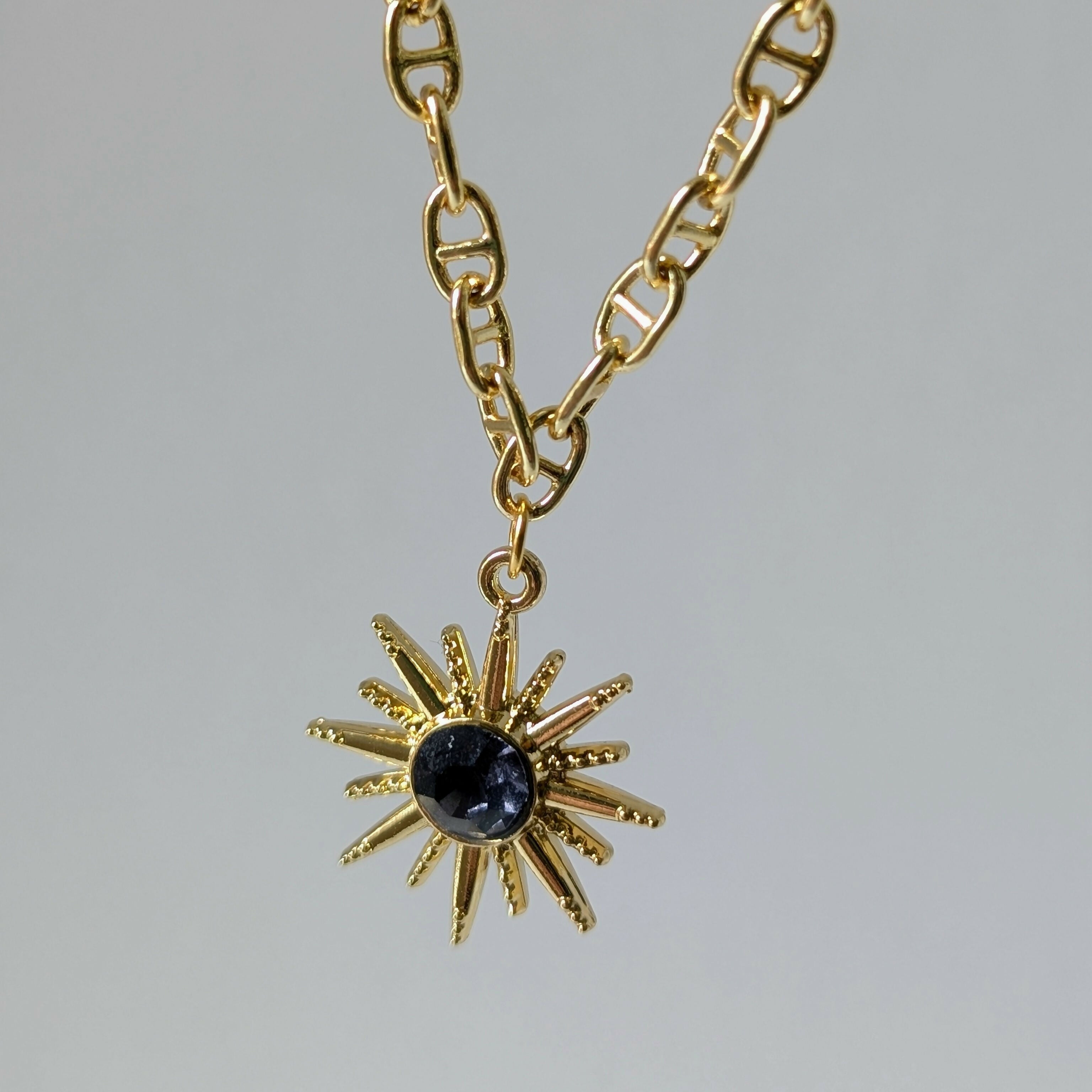 Gold Starburst Necklace with Deep Purple Stone on Gold Plated Deco Oval Chain