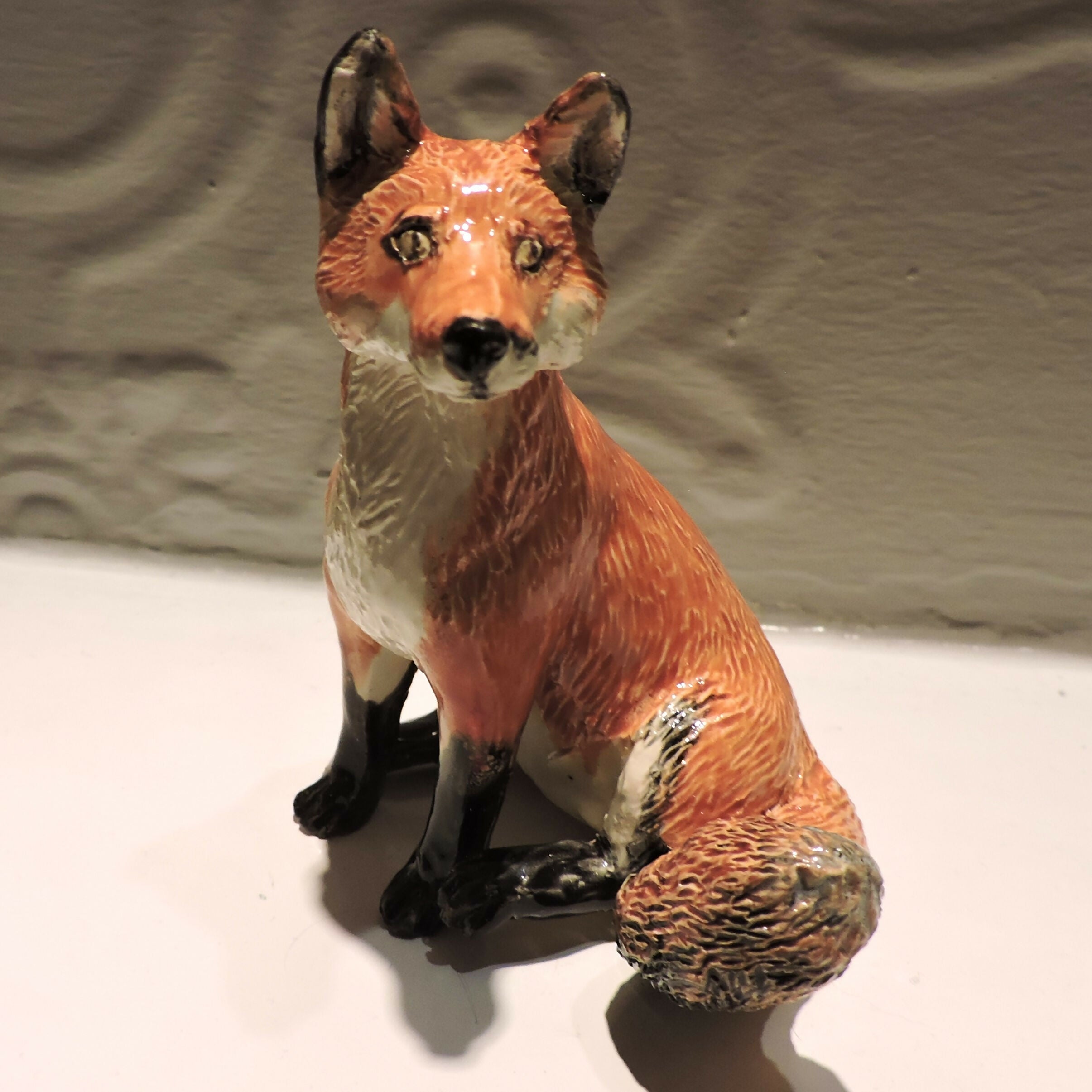 Ceramic sitting fox sculpture