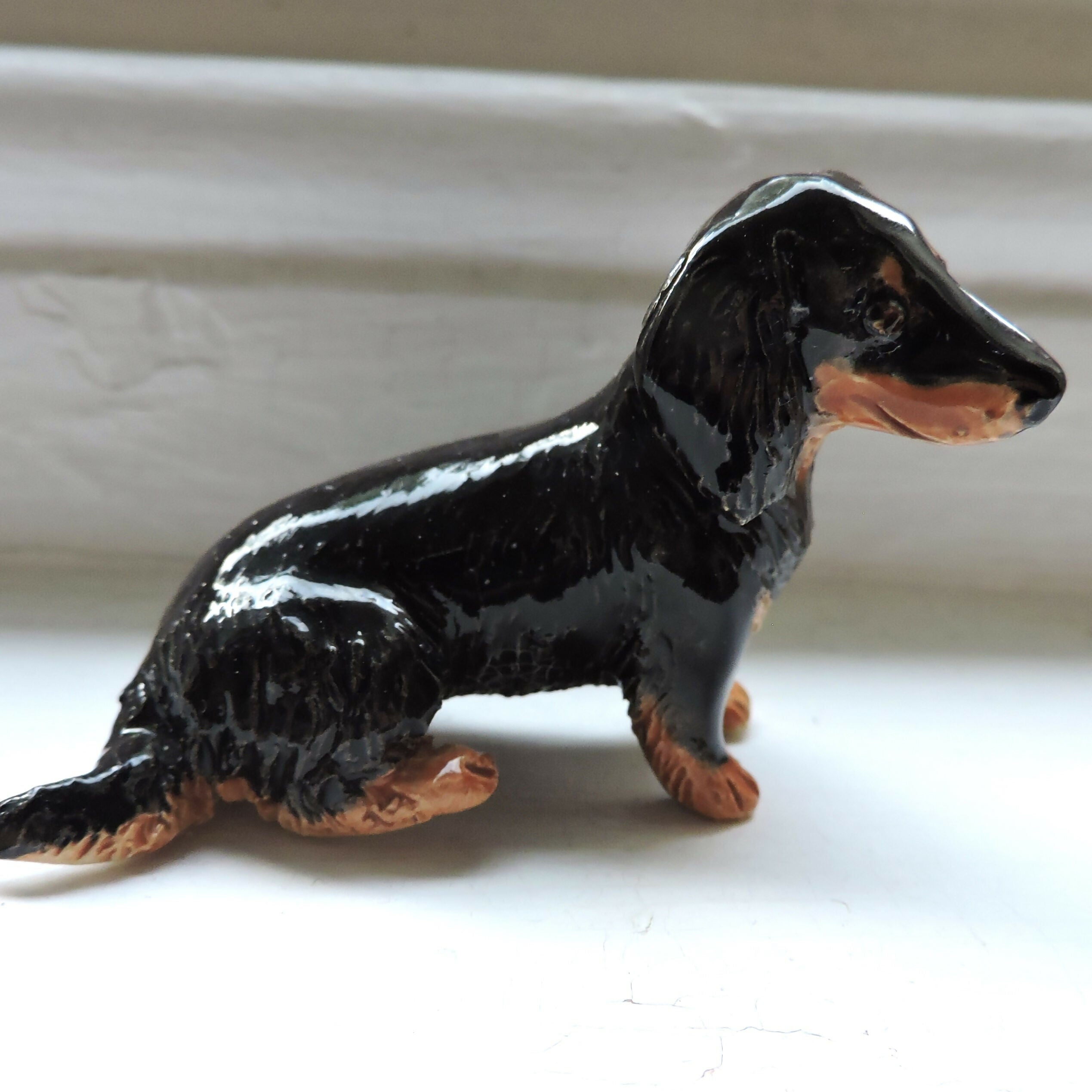 Ceramic Longhaired Black and tan dachshund dog sculpture