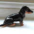 Ceramic Longhaired Black and tan dachshund dog sculpture
