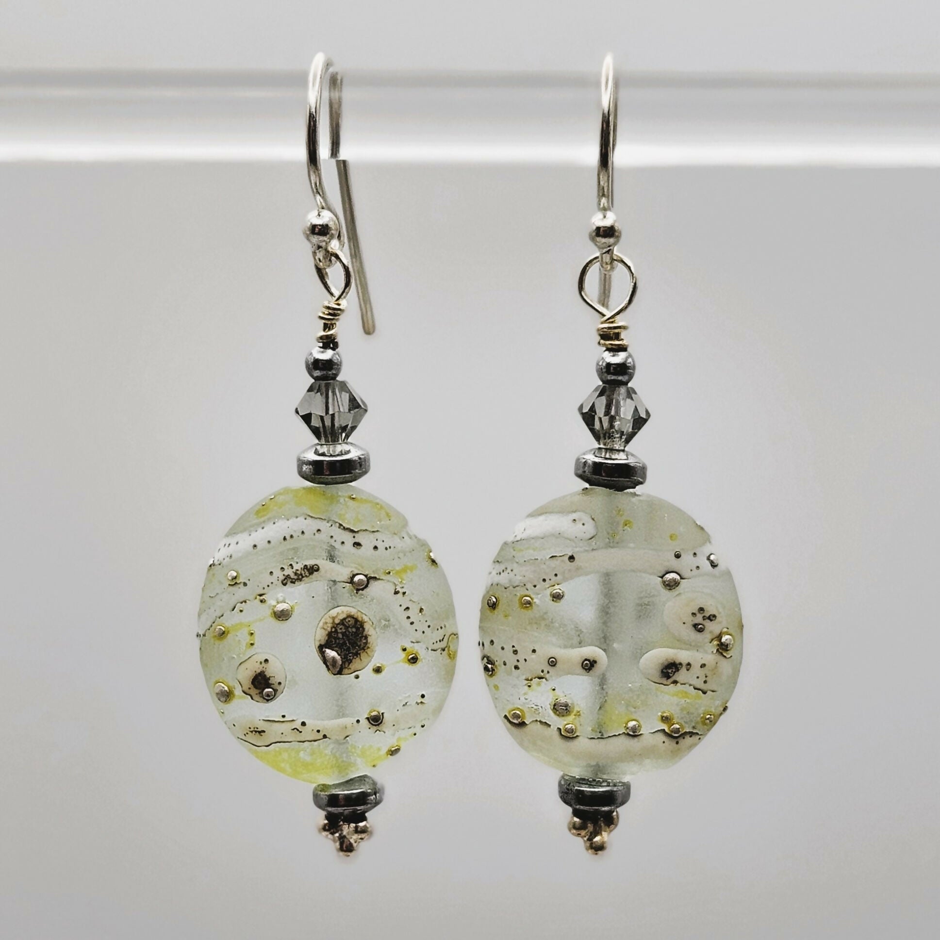 HAND LAMPWORKED ETCHED DROP GLASS EARRINGS, WITH STERLING SILVER EAR WIRES AND SWAROVSKI CRYSTALS.
