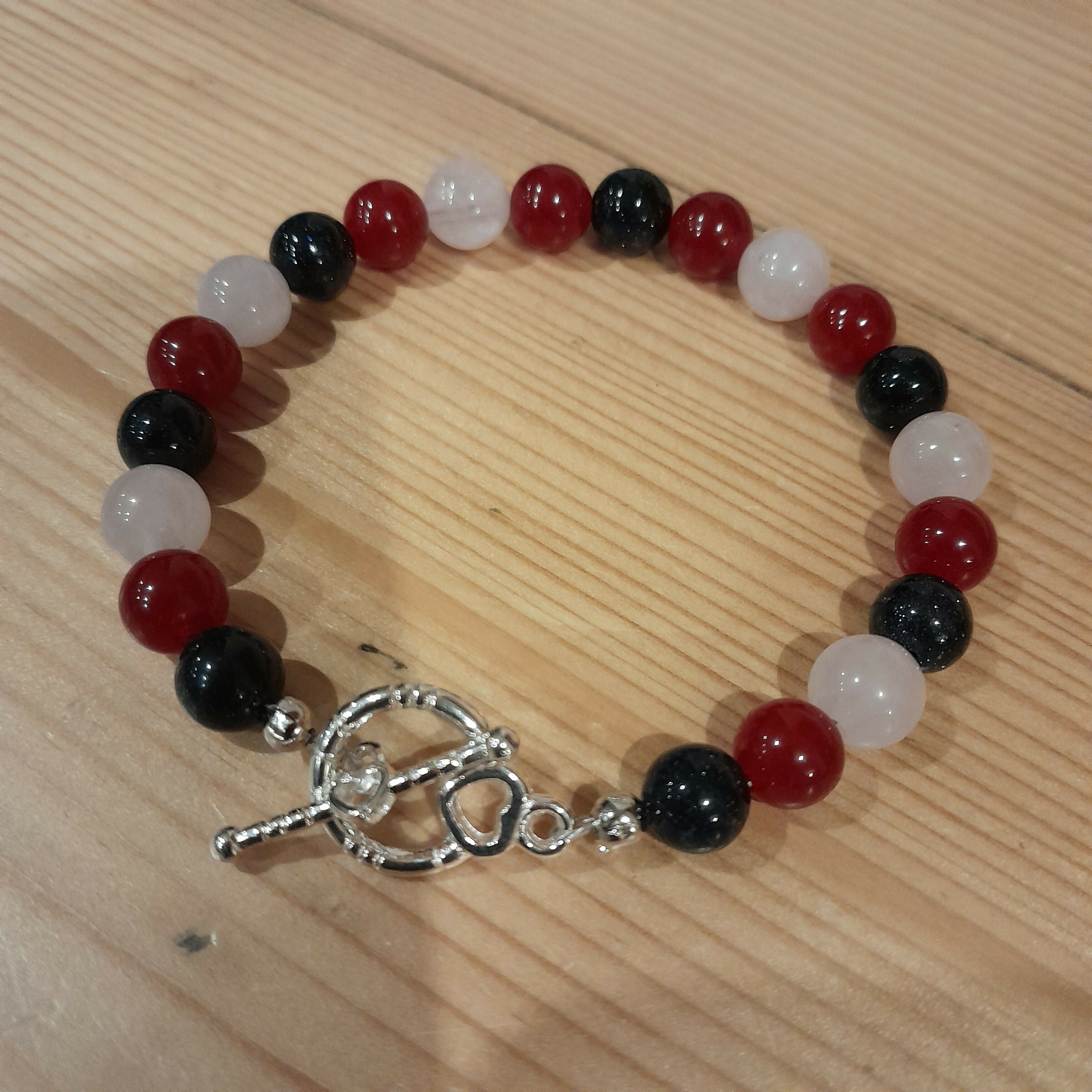 Tibetan Silver Toggle Catch Bracelet with Navy Goldstone, Red Chalcedony and Rose Quartz.