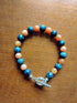 Tibetan Silver toggle Catch Bracelet with Blue Spot Jasper & Orange Chalcedony.