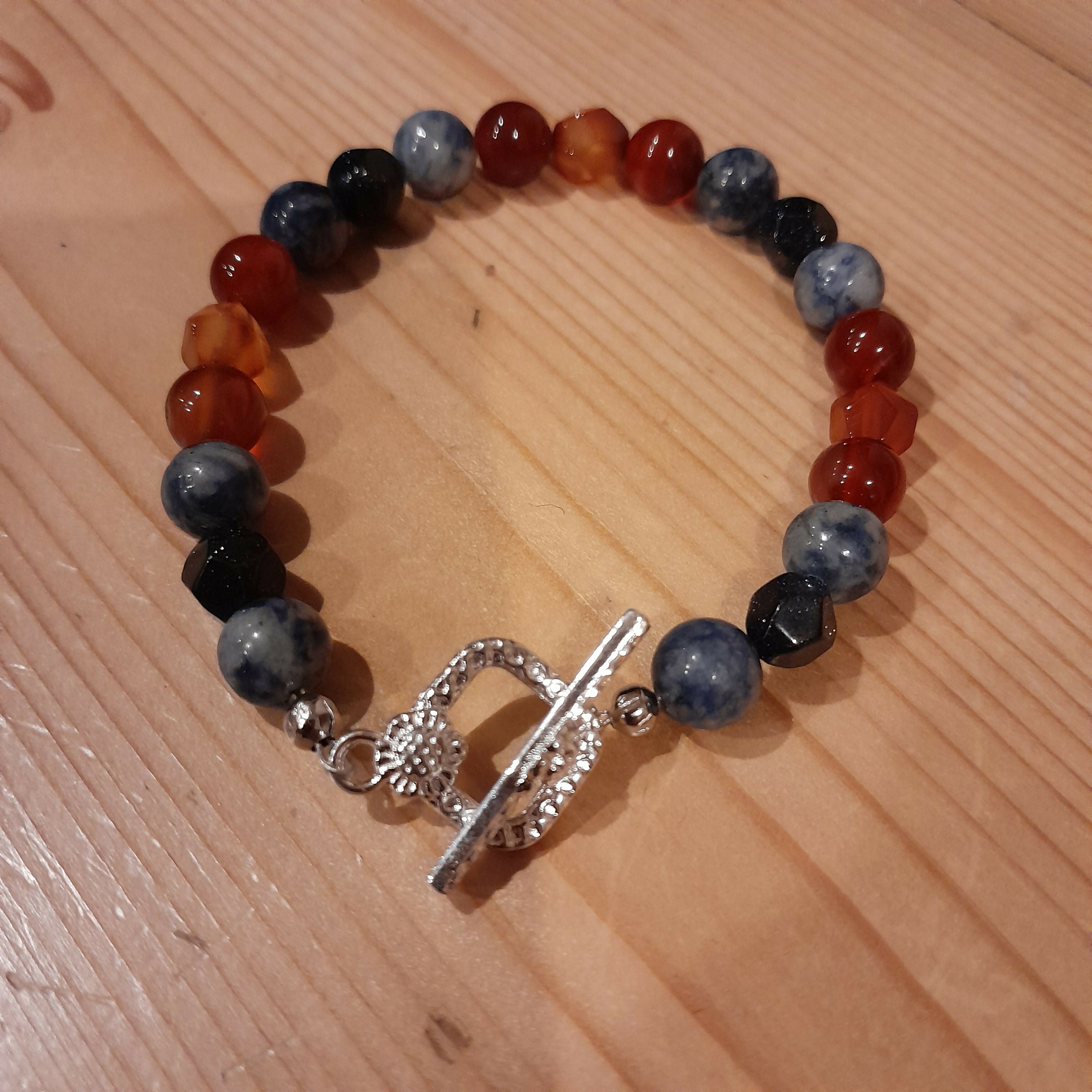 Tibetan Silver Toggle Catch Bracelet with Spotted Blue Jasper, Faceted Navy Goldstone and Carnelian.