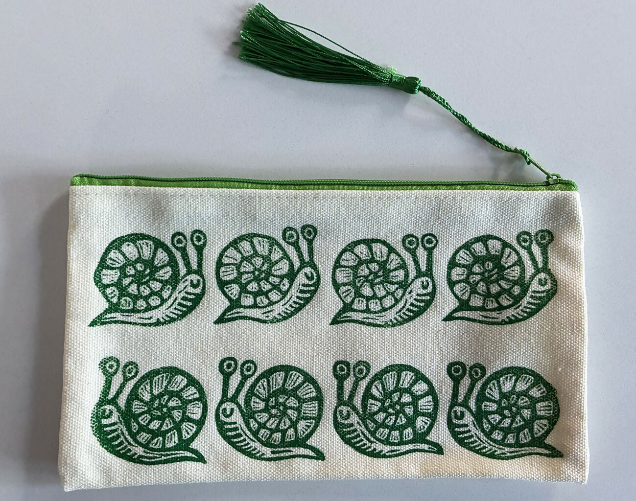 Hand Printed Zip Pouch with Green Snail Design.