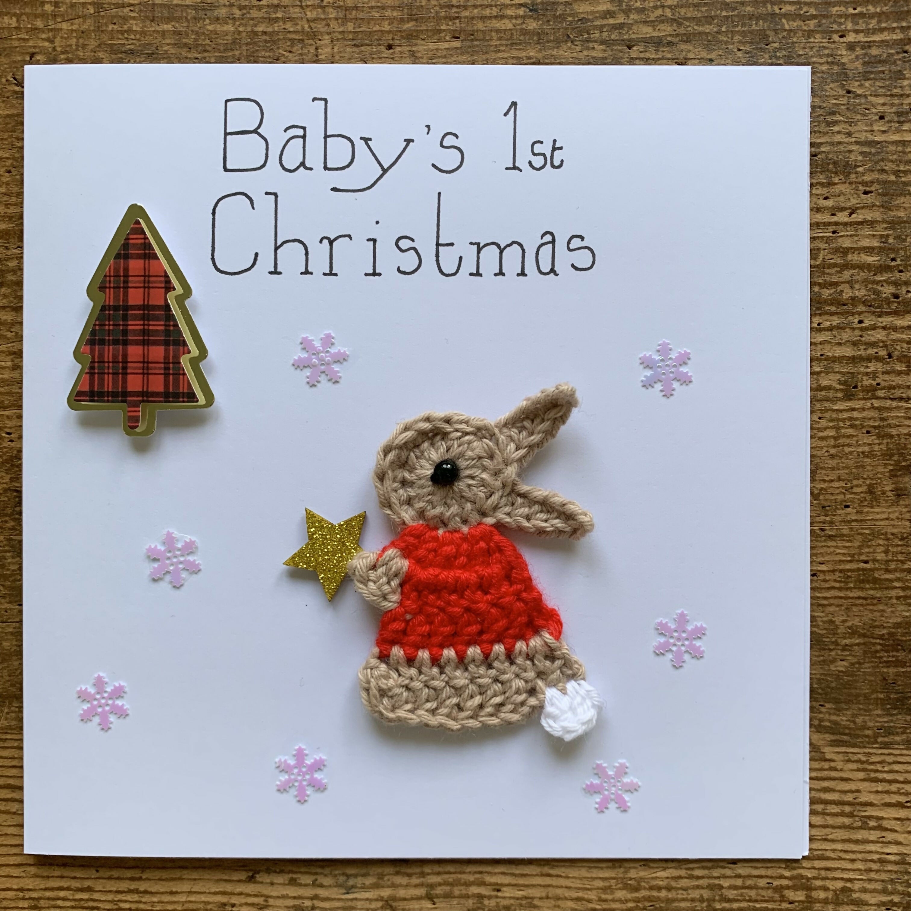 Christmas Card with Crocheted Rabbit Putting Star on the Christmas tree.