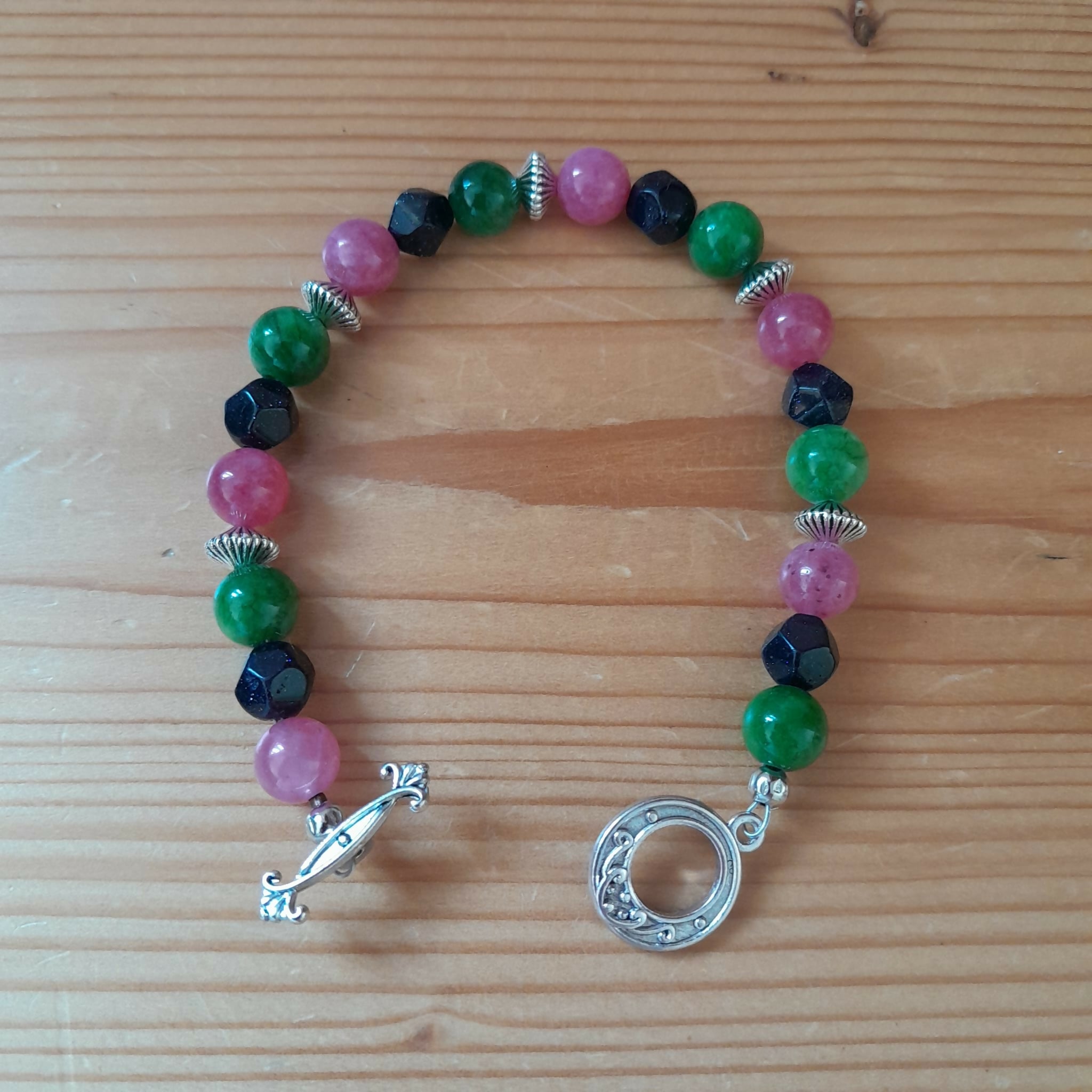 Tibetan Silver Toggle Catch Bracelet with Pea Green Chalcedony, Faceted Navy Goldstone, Strawberry Quartz and Tibetan Silver Beads.