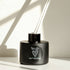 Reed Diffuser with black glass bottle and white reeds