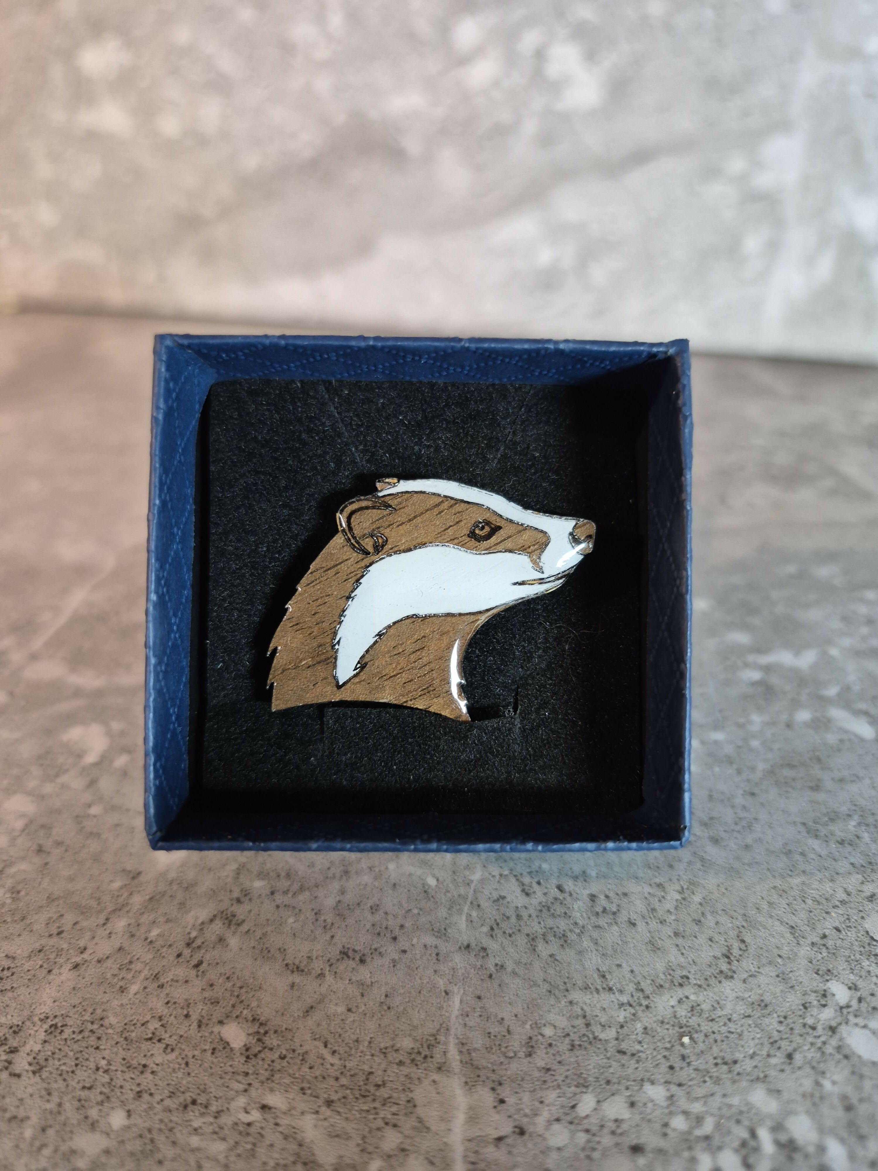 Handcrafted Walnut veneered badger head pin.