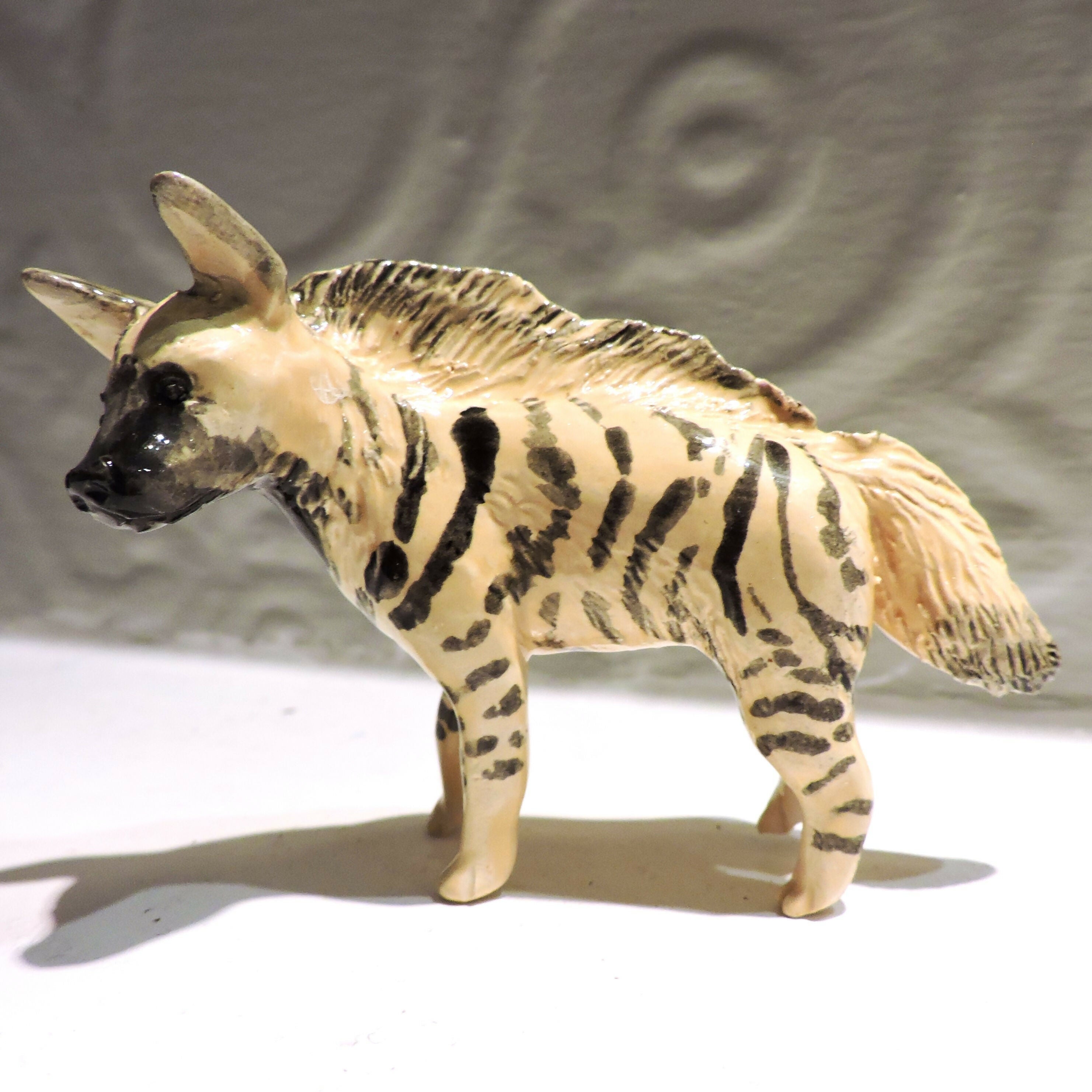 Ceramic striped hyena sculpture