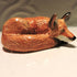 Ceramic curled up fox sculpture