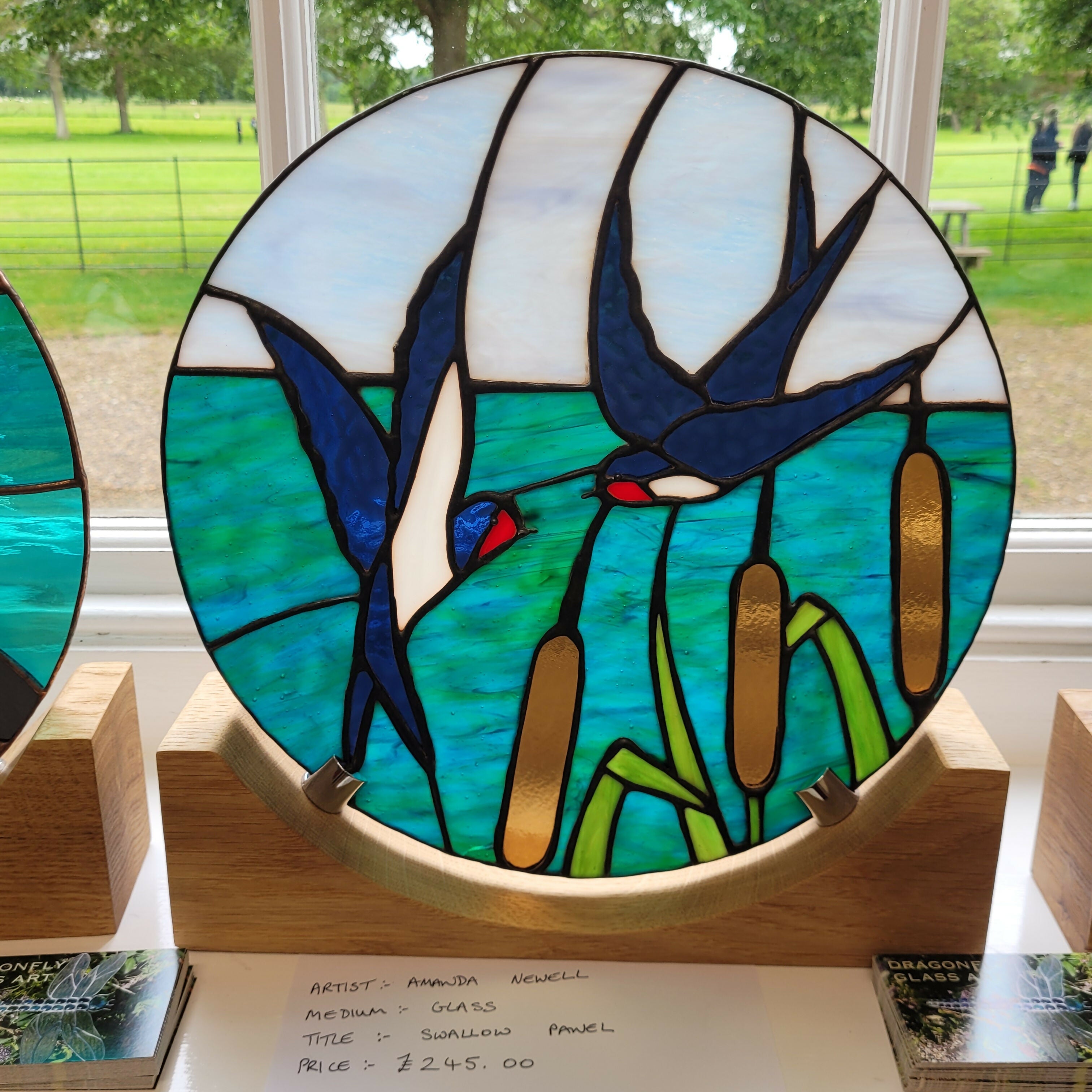 Glass Swallow Panel on oak wood display