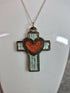 Handcrafted and engraved walnut veneered cross with a heart pendent.