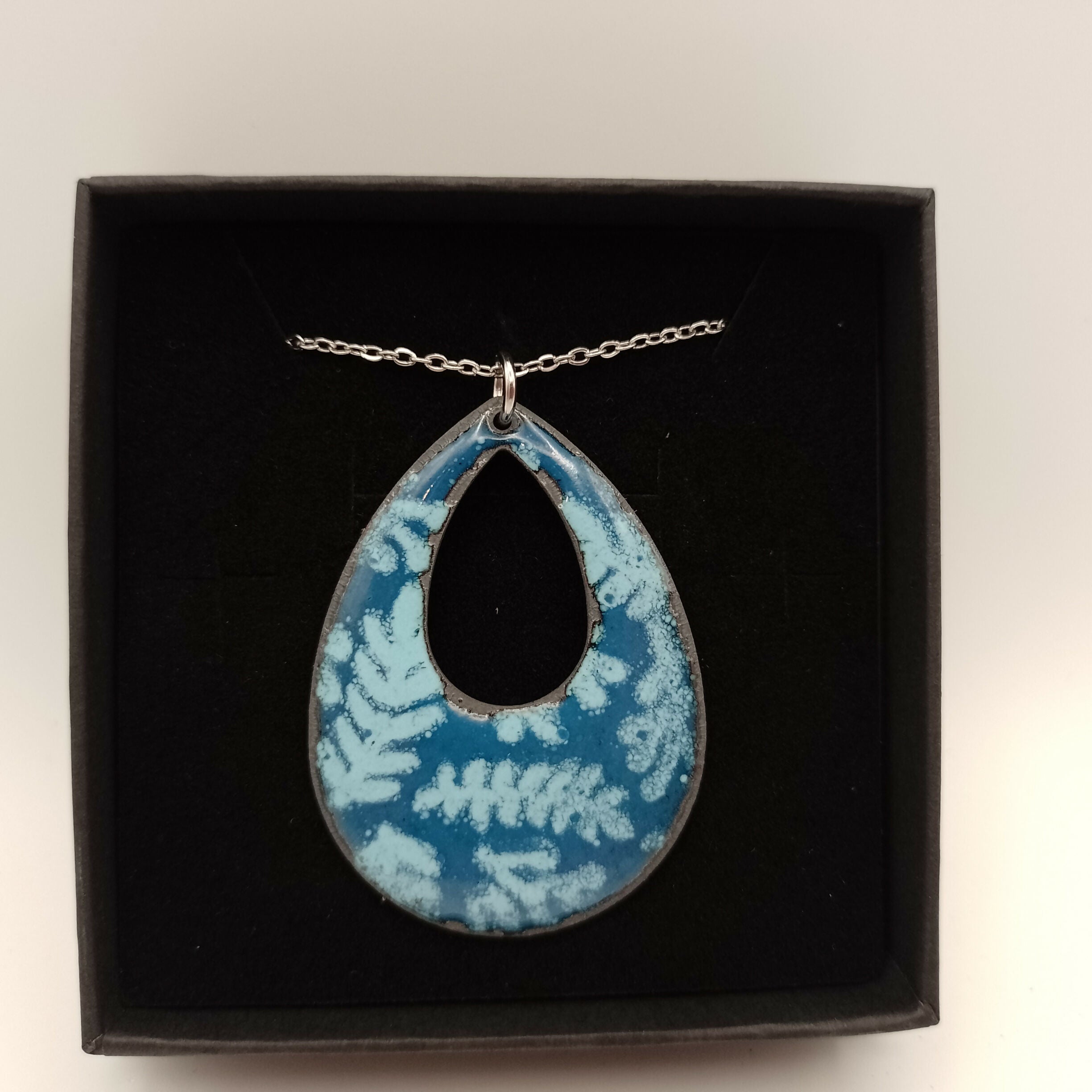 Blue Enamel Oval Pendant With White Leaf Pattern