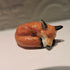 Ceramic sleeping fox sculpture